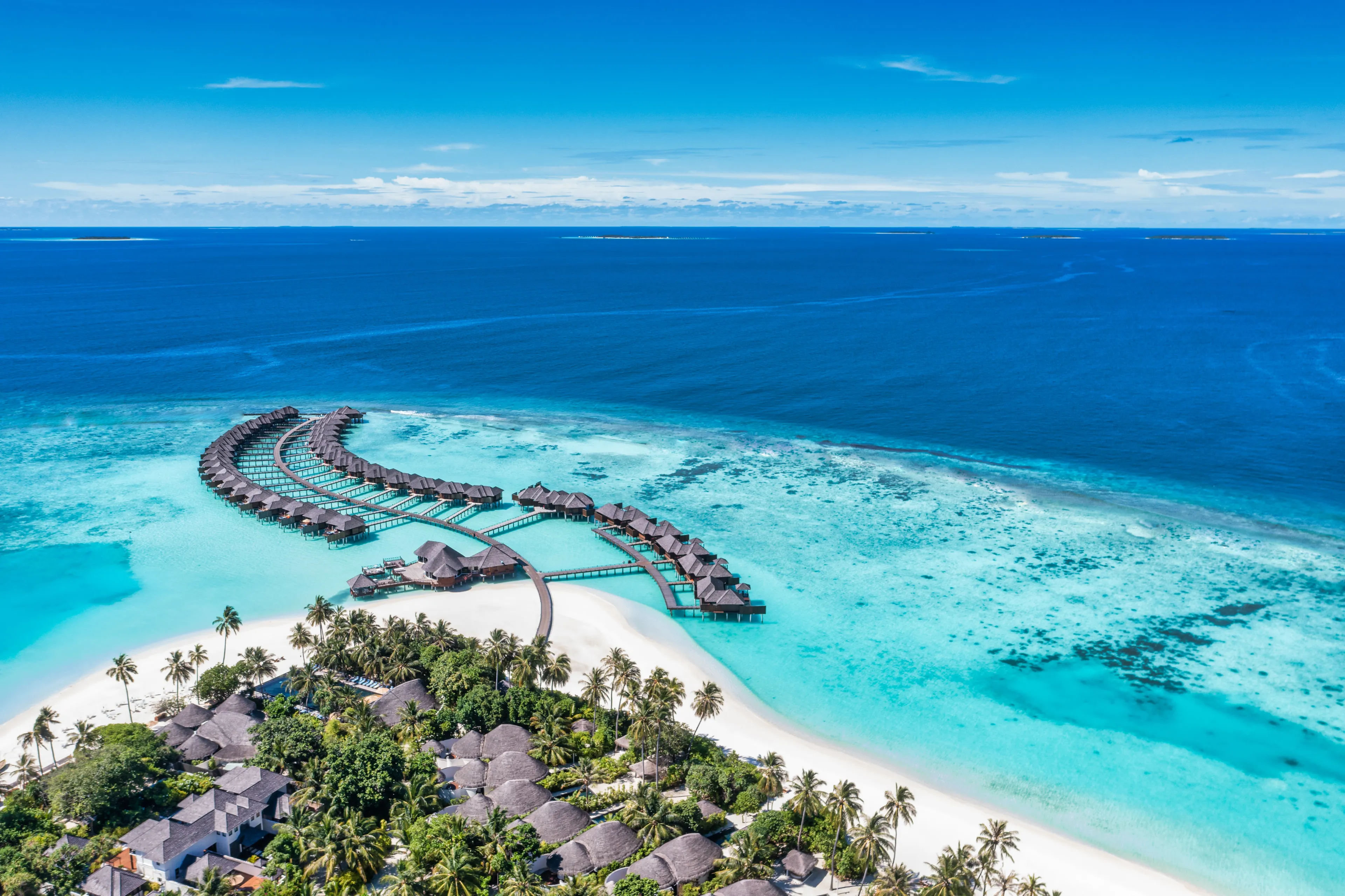 Maldives paradise island. Tropical aerial landscape, seascape with jetty, water bungalows villas with amazing sea lagoon beach. Exotic tourism destination, summer vacation background. Aerial travel