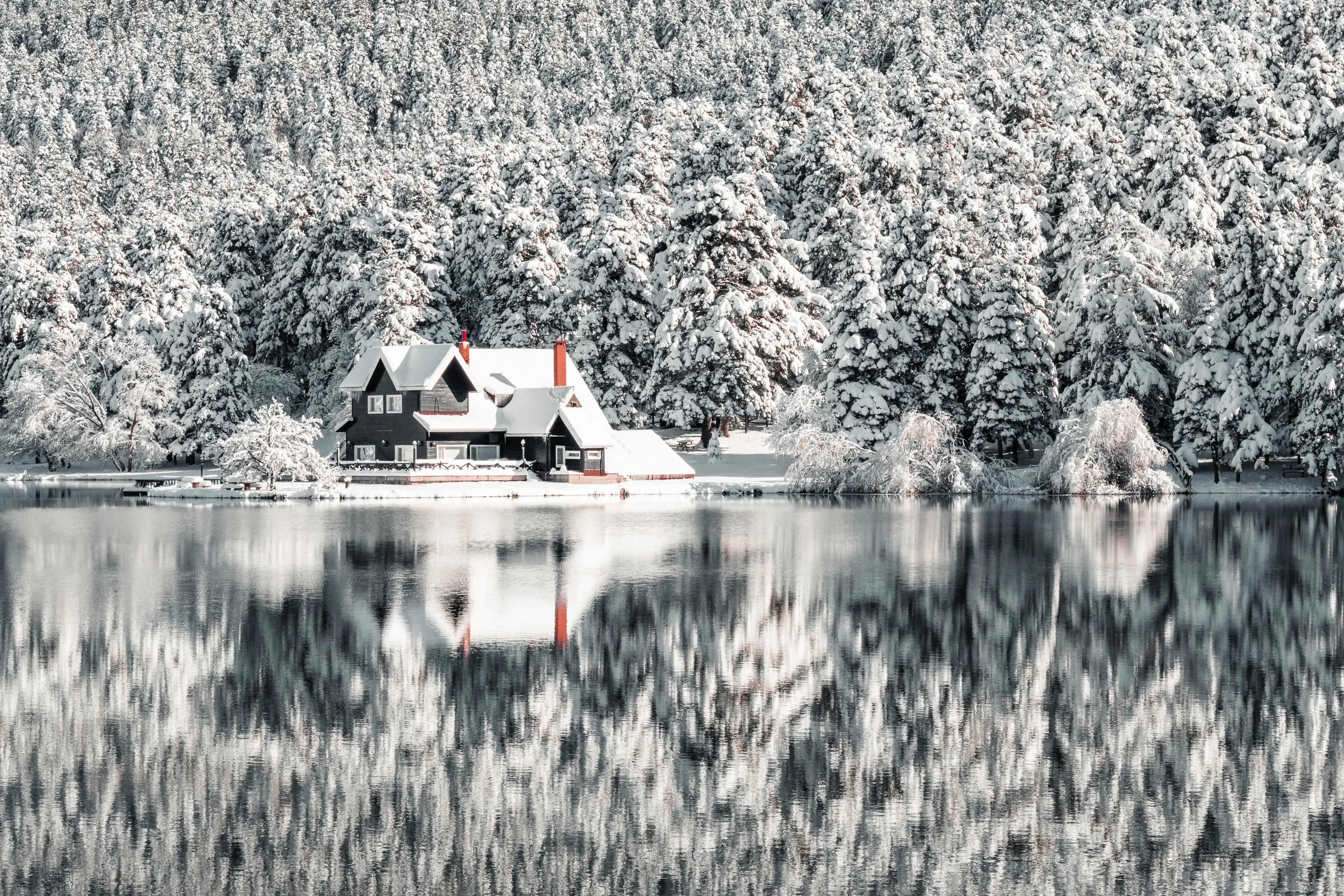 Bolu Golcuk National Park, lake wooden house on a snowy winter day in the forest in Turkey