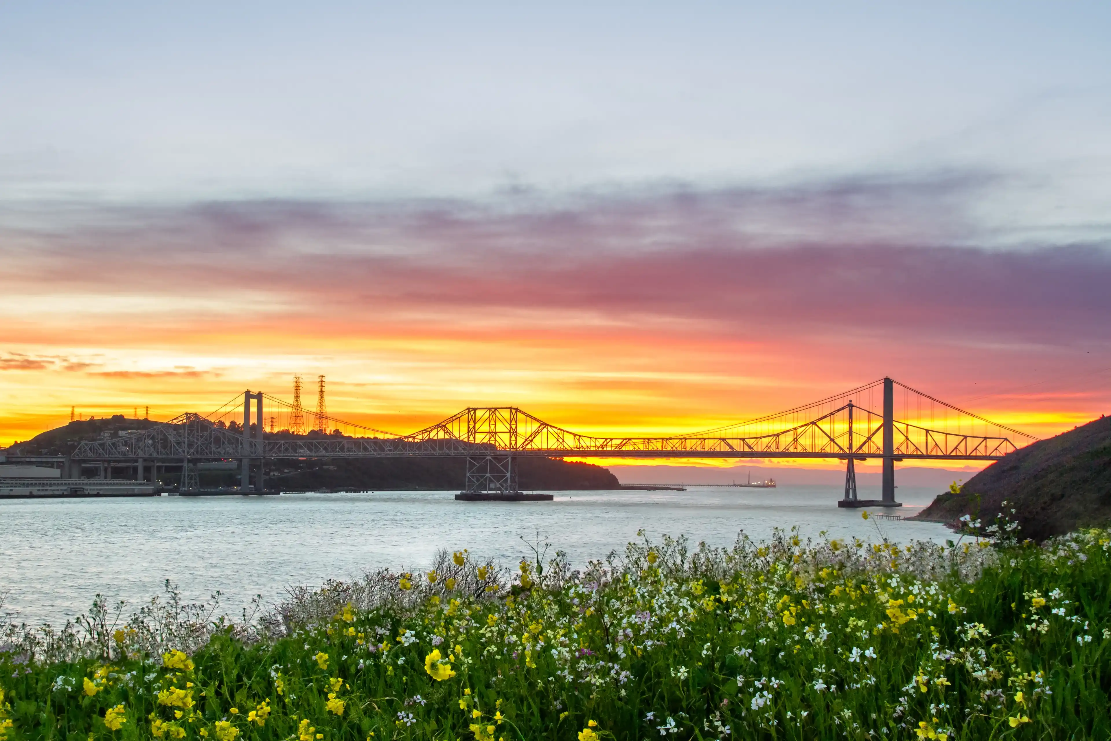 Sunset lights up the sky behind the Carquinez bridge in the Bay area of California. Sunset lights up the sky behind the Carquinez bridge in the Bay area of California.