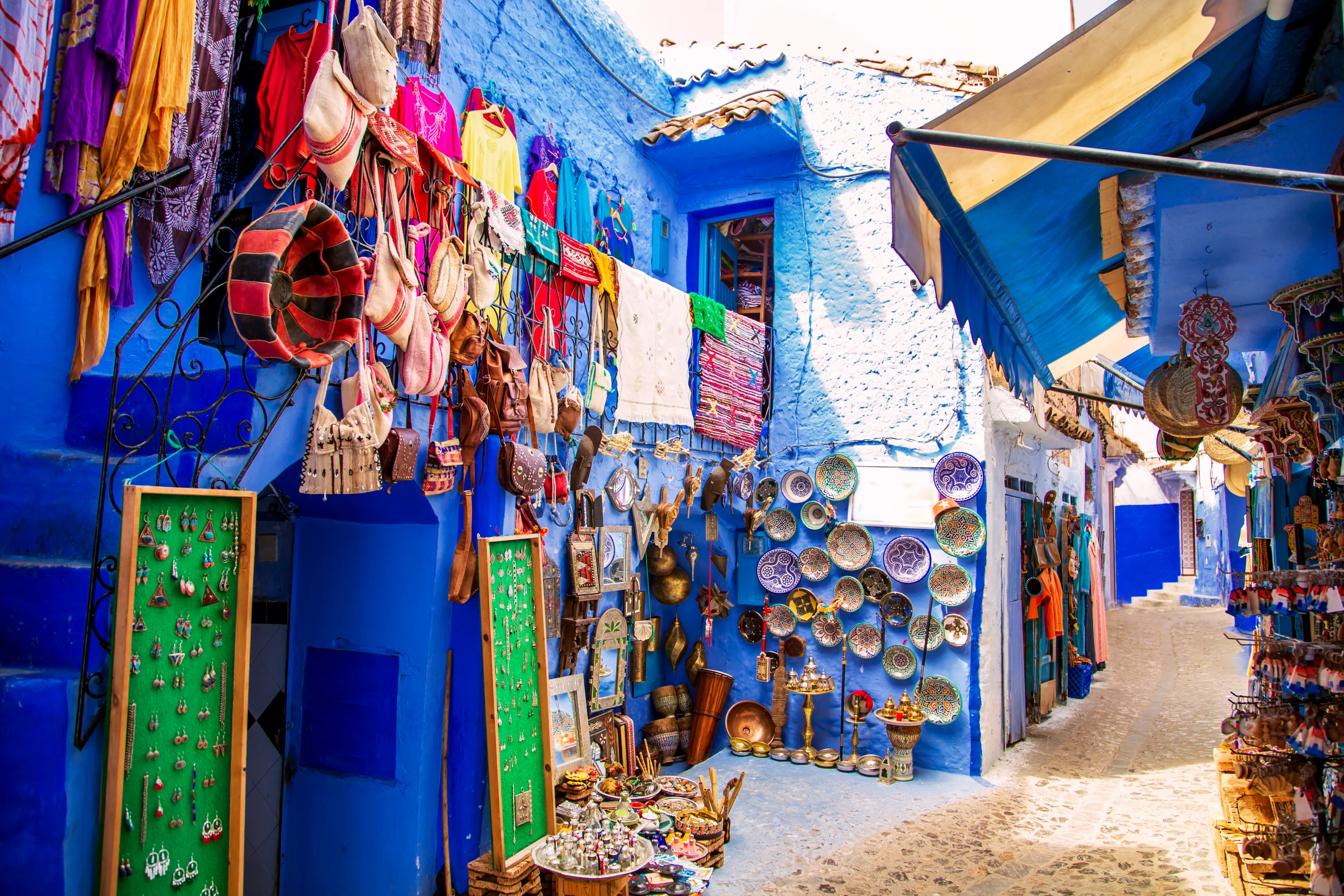 Traditional carpets on the blue Chefchaouen street. Chefchaouen, Morocco - September 13, 2019.