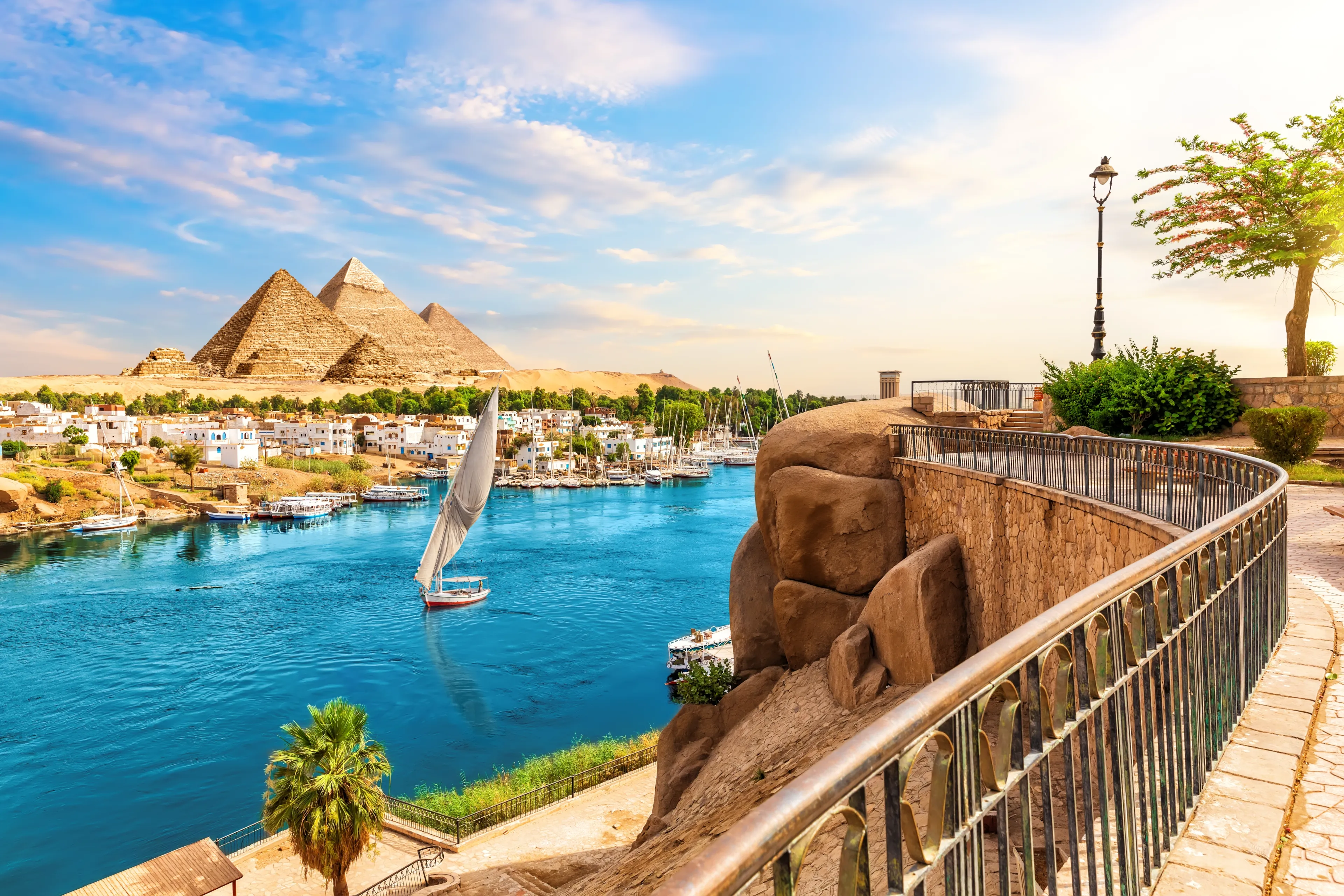Skyline view of Aswan with sailboats in the Nile on the way to pyramids, Egypt