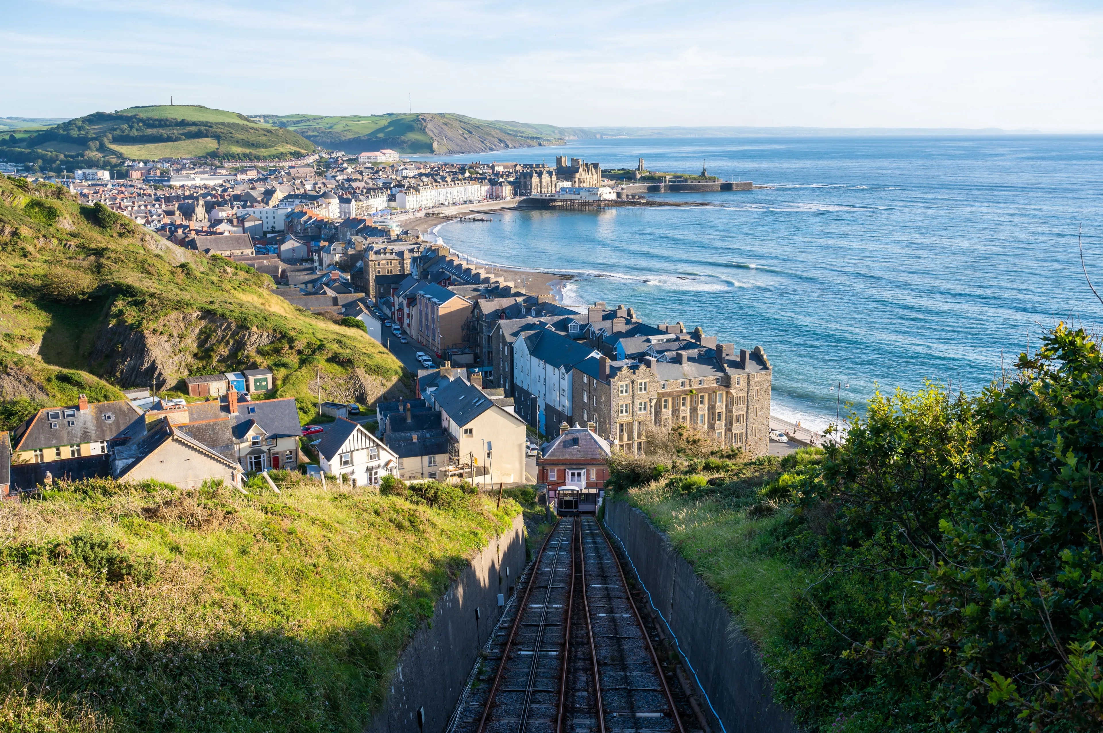 A railroad taking to Aberystwyth town of Wales with a view of the sea