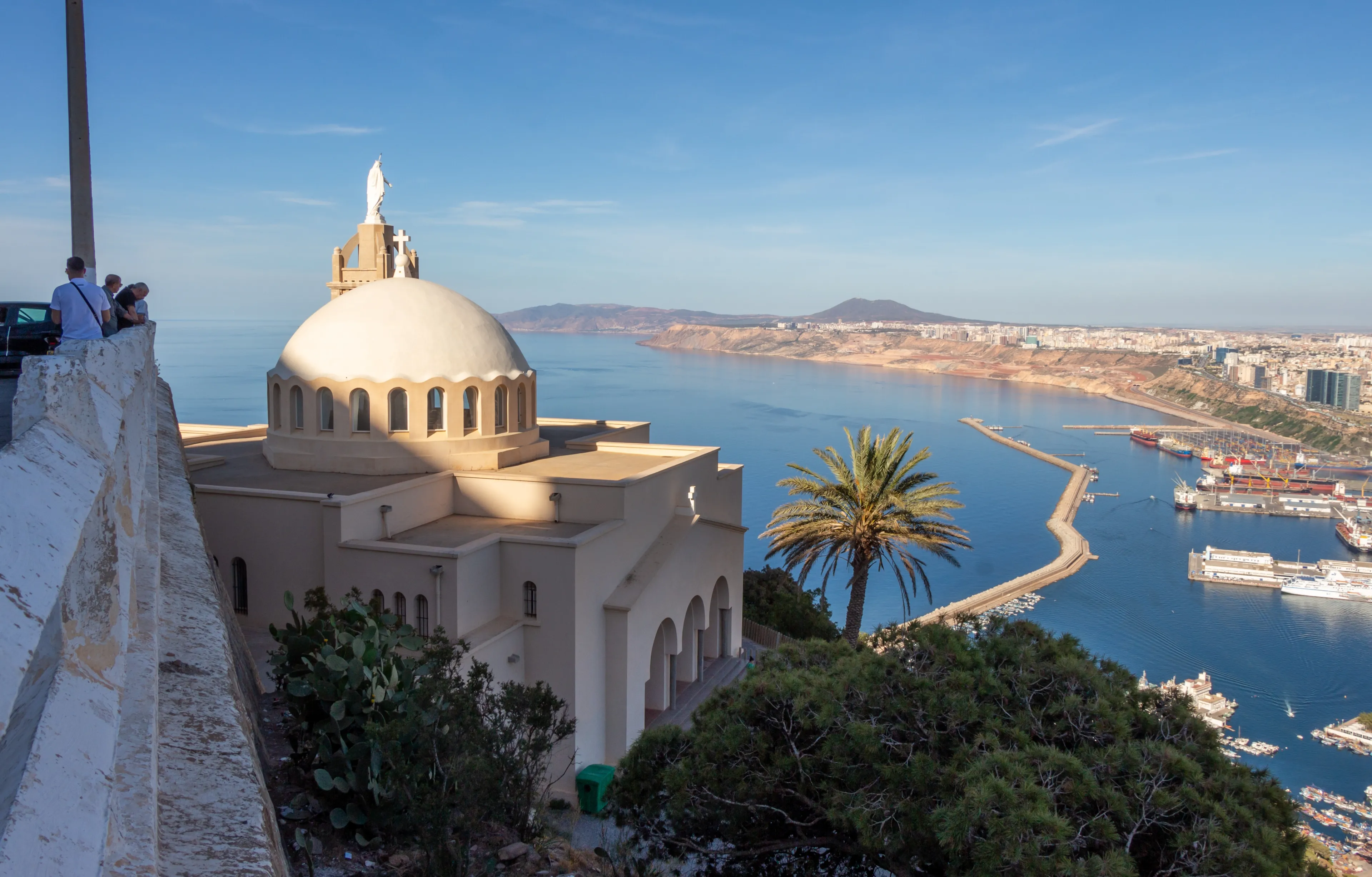 Panoramic view of Oran, Algeria, with the Santa Cruz chapel in the foreground. People looking at the city.