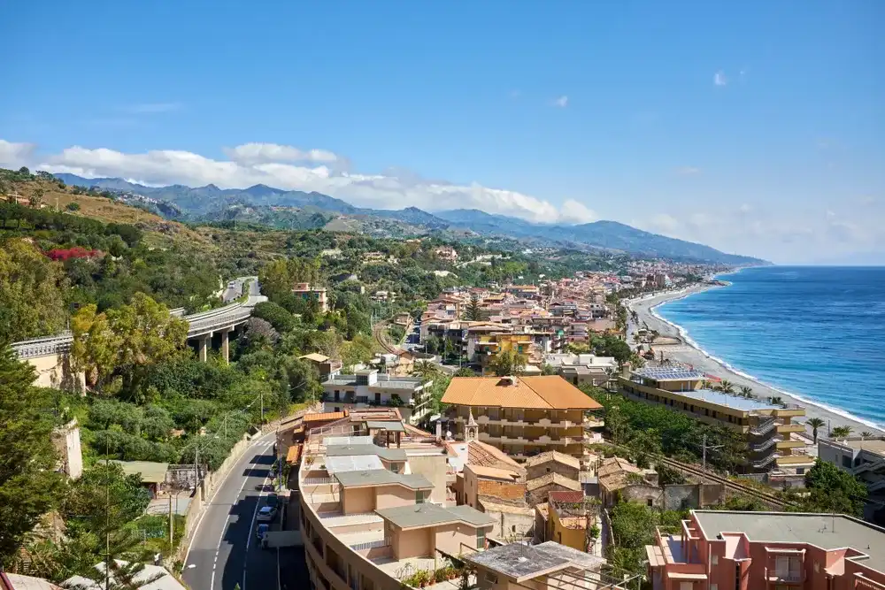 view of the village of Santa Teresa di Riva on the Ionic Coast of SIciliana and the Strait of Messina in the background view of the village of Santa Teresa di Riva on the Ionic Coast of SIciliana and the Strait of Messina in the background