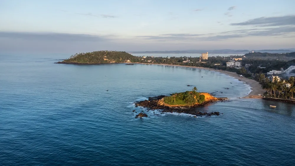 Mirissa, Sri Lanka. Aerial view of all coast at morning. Long flight along the beach and Parrot Rock