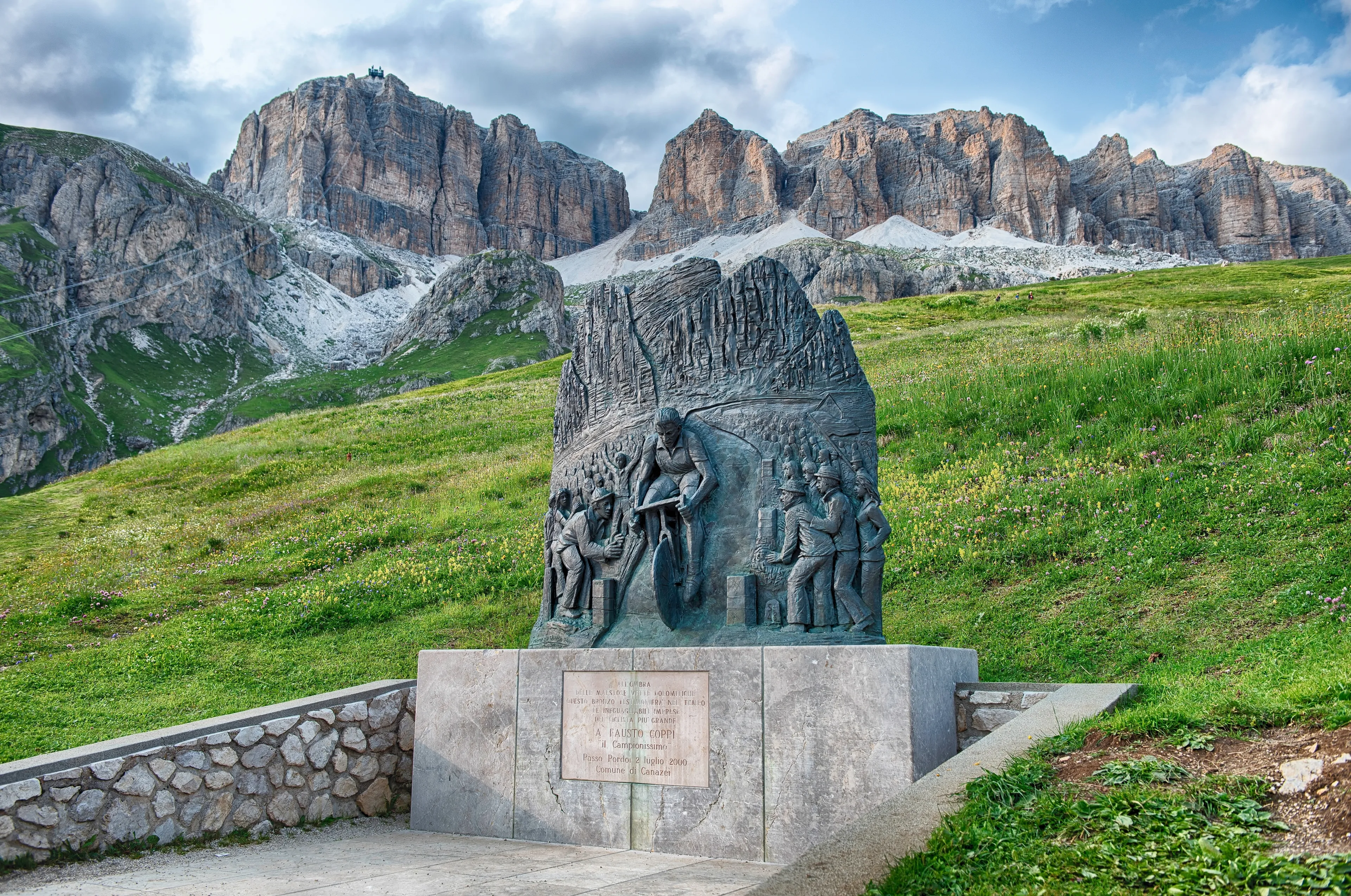CANAZEI, ITALY - JULY 24, 2024: Bronze monument depicting cyclist Fausto Coppi winning a stage of the Giro d'Italia at the Pordoi Pass, Dolomites of Canazei, Italy