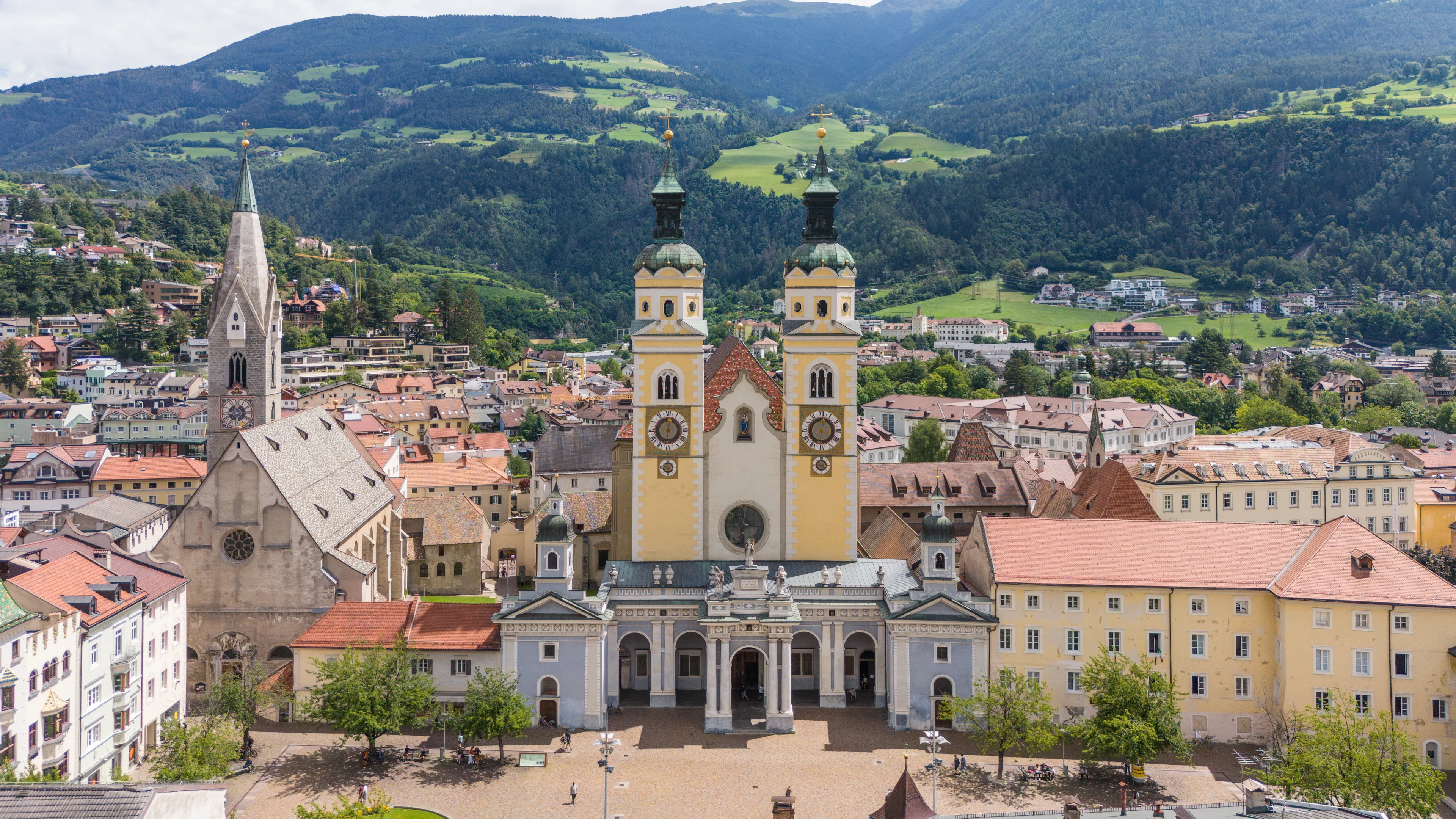 aerial drone view, Brixen, Bressanone city. View on the grand place with the cathedral and St. Michael church. sunny summer view. Photo for tourist brochure, publicity. City in south Tyrol.