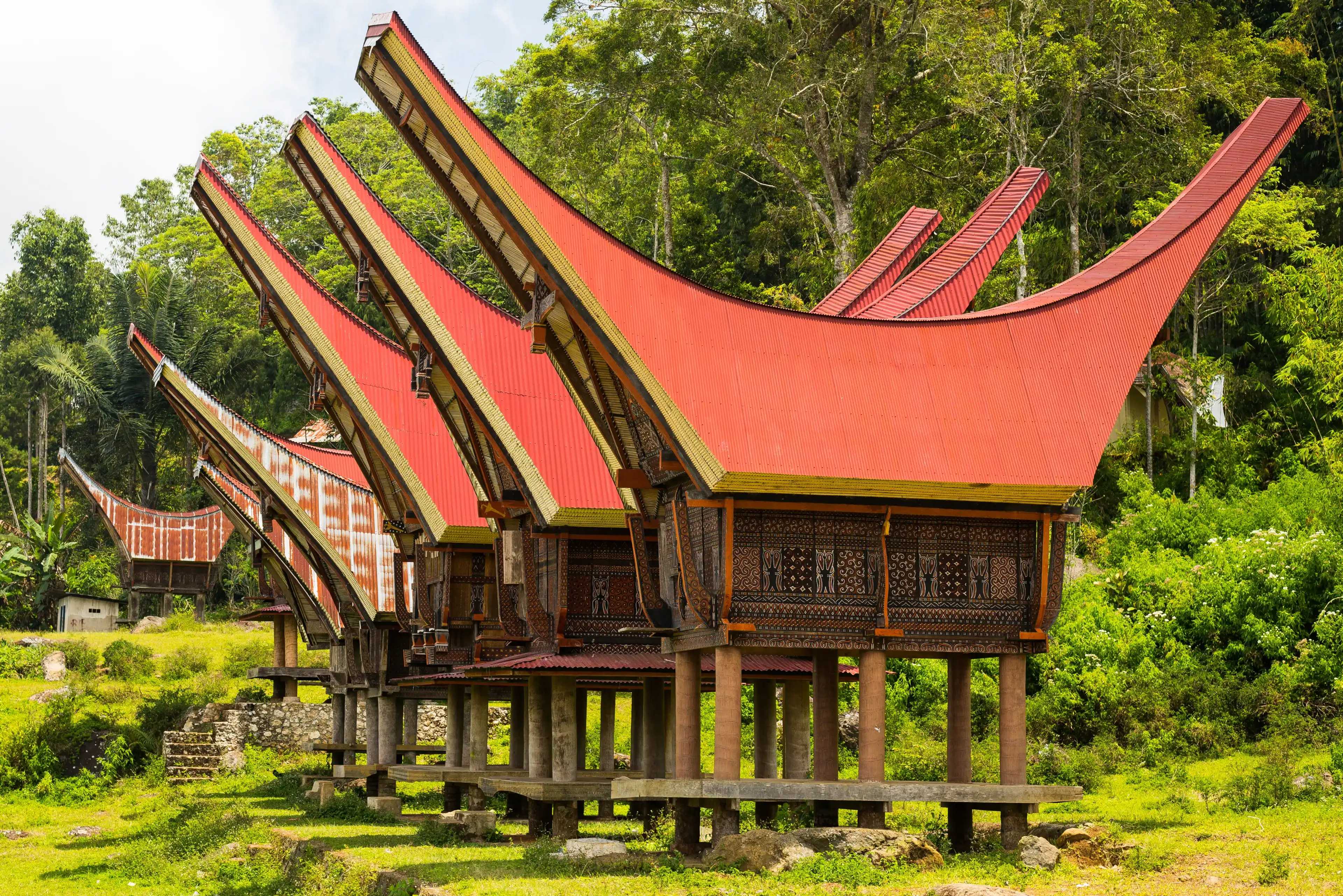 Traditional village of residential buildings with decorated facade and boat shaped roofs. Tana Toraja, South Sulawesi, Indonesia. Traditional village of residential buildings with decorated facade and boat shaped roofs. Tana Toraja, South Sulawesi, Indonesia.