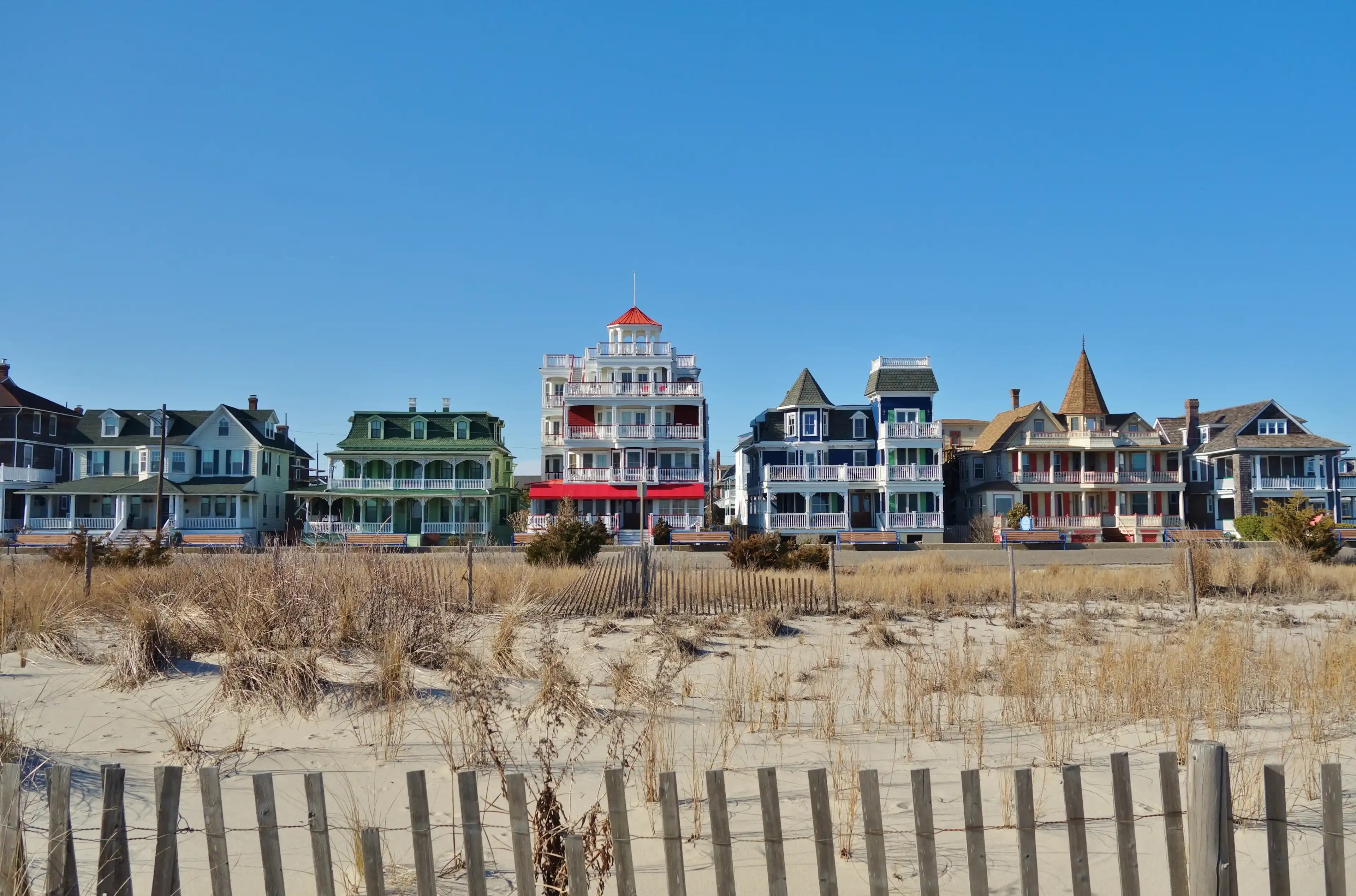 CAPE MAY, NJ -31 MAR 2018- Colorful historic Victorian houses line the beach front in Cape May, at the southern tip of Cape May Peninsula in New Jersey where the Delaware Bay and Atlantic Ocean meet. CAPE MAY, NJ -31 MAR 2018- Colorful historic Victorian houses line the beach front in Cape May, at the southern tip of Cape May Peninsula in New Jersey where the Delaware Bay and Atlantic Ocean meet.