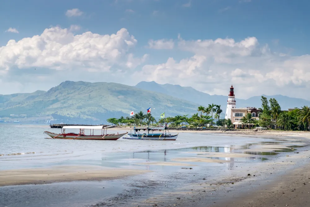 Traditional Filipino Rowboats on Subic Beach and Lighthouse in Late Afternoon - Subic, Philippines