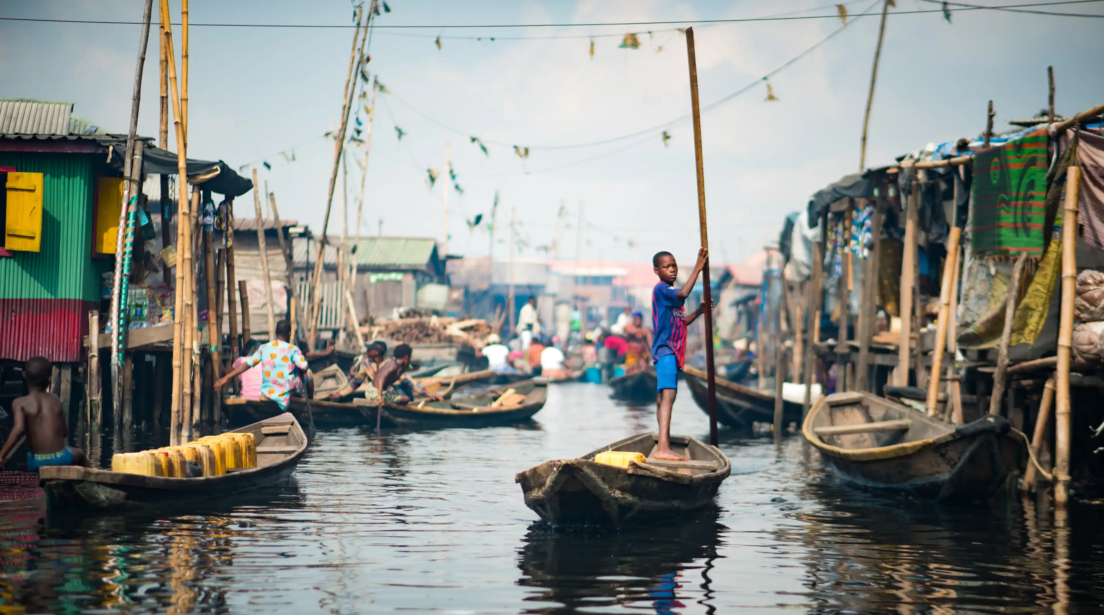 A young boy rowing a Canoe in the Makoko Stilts Village, Lagos/ Nigeria taken on the 18th of May, 2019 A young boy rowing a Canoe in the Makoko Stilts Village, Lagos/ Nigeria taken on the 18th of May, 2019