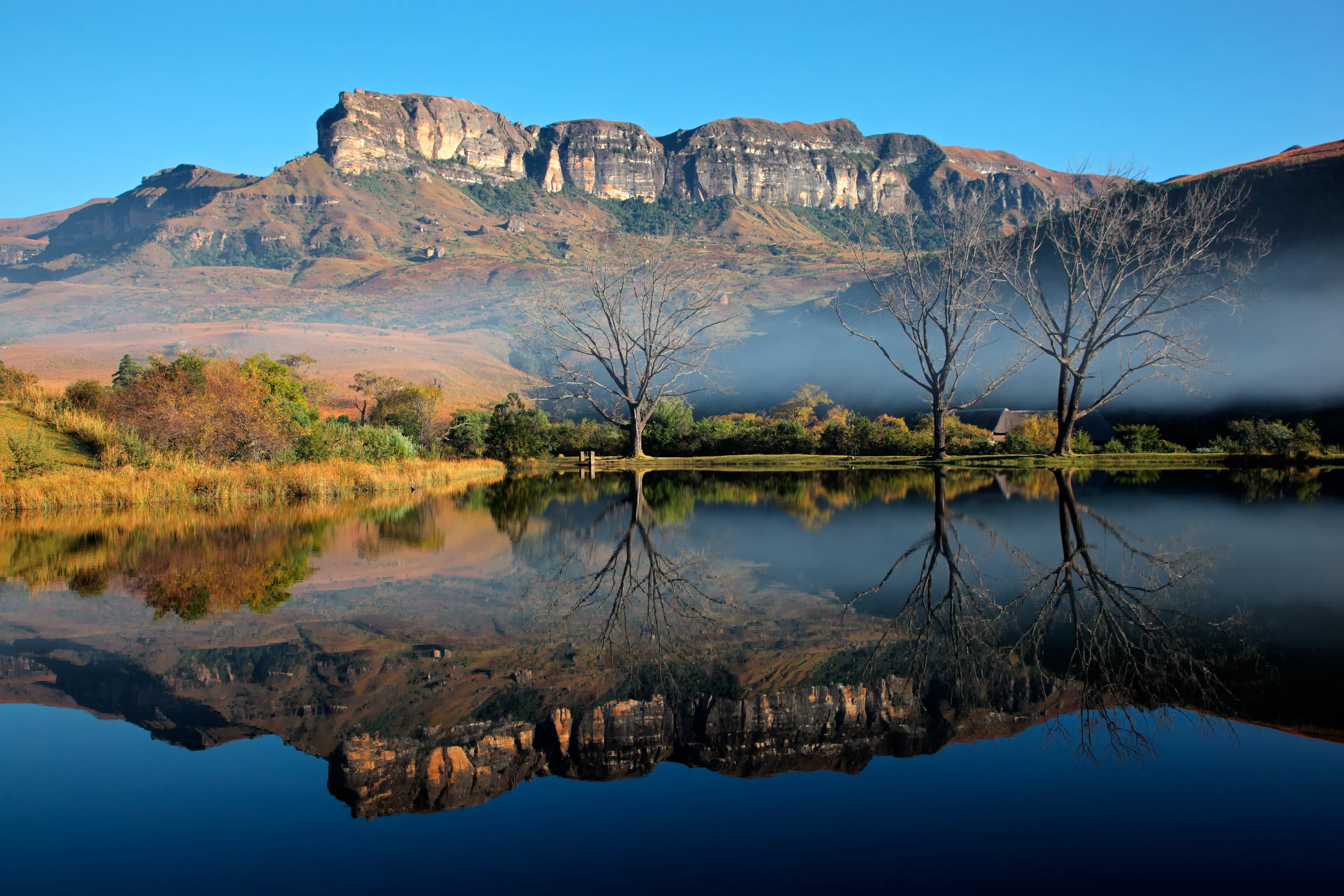 Sandstone mountains with symmetrical reflection in water, Royal Natal National Park, South Africa 