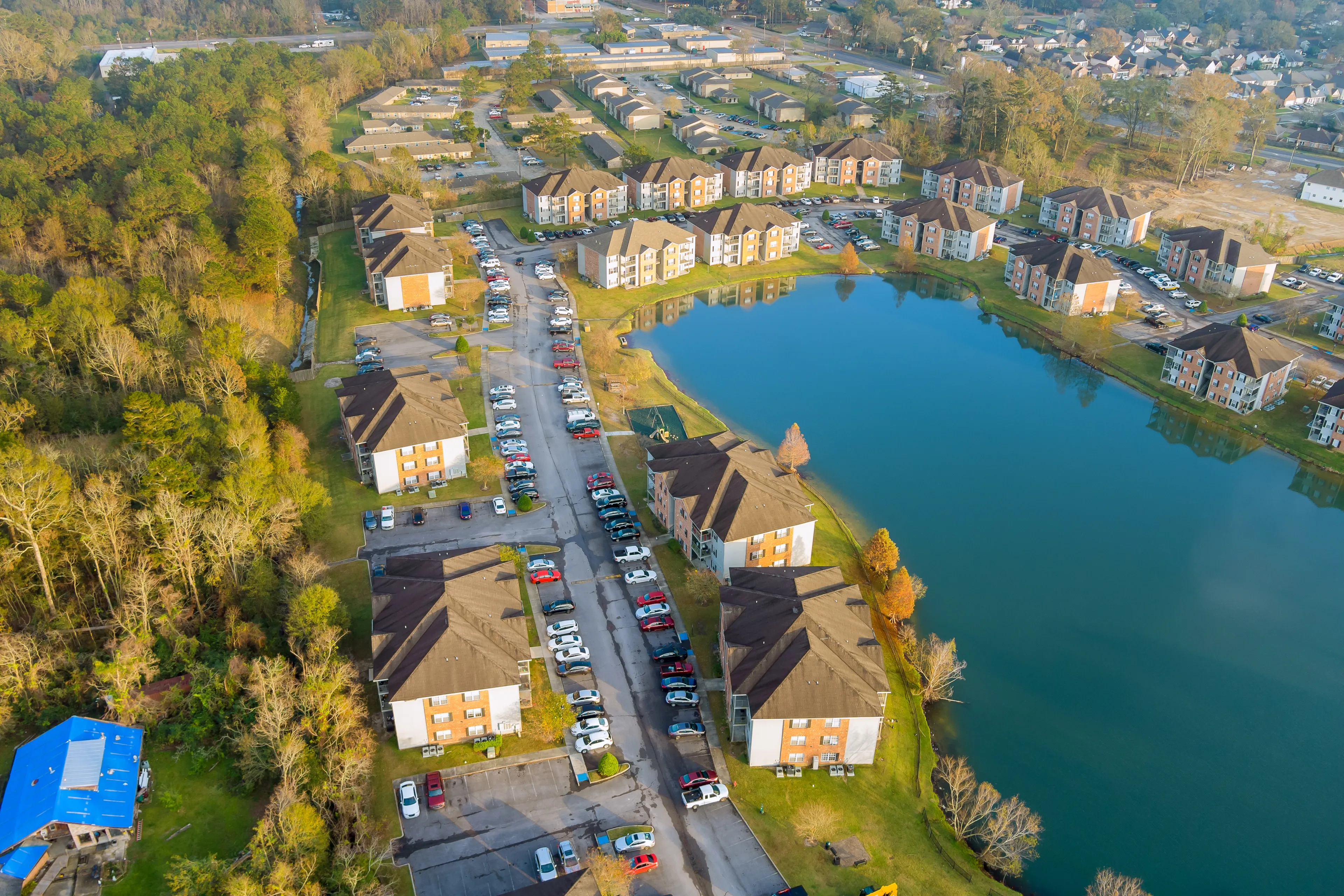 Autumn season residential street, apartment complex near pond from above small town in Denham Springs Louisiana America