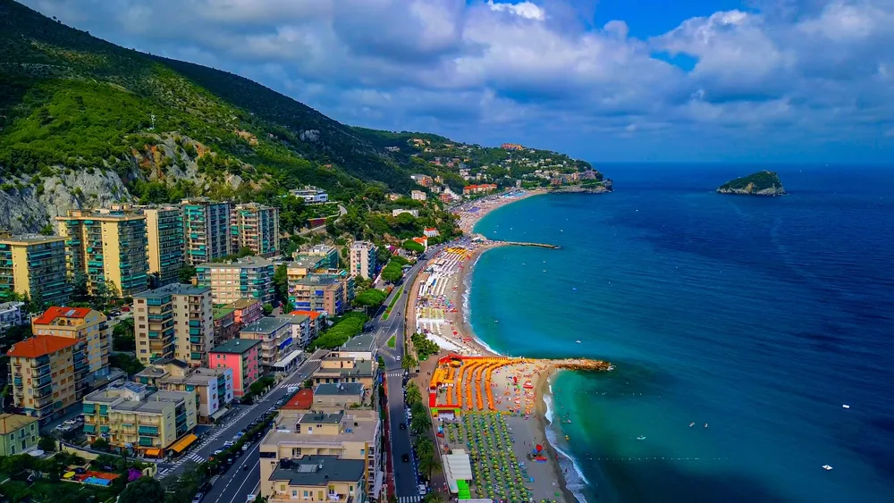 Aerial view of the beaches with umbrellas on the mediterranean coast. Spotorno is a commune in Italy, in the Liguria region, in the province of Savona. Pure salt water. Spotorno Italy 28.07.2023