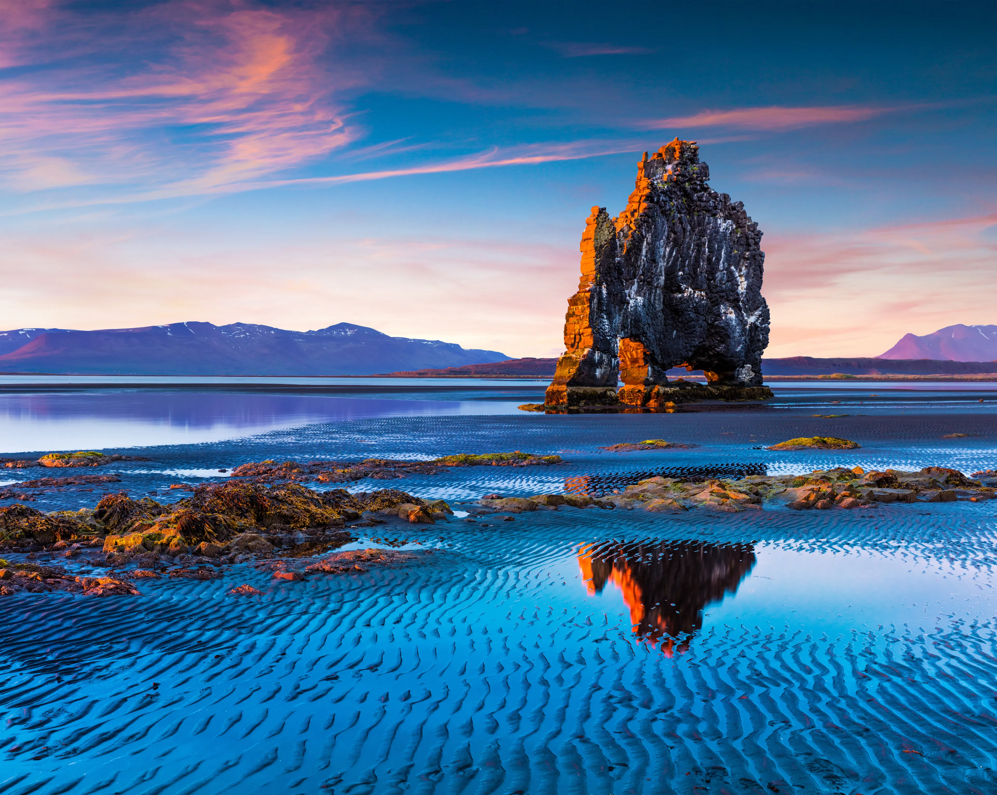 Huge basalt stack Hvitserkur on the eastern shore of the Vatnsnes peninsula. Colorful summer sunrise in northwest Iceland, Europe. Artistic style post processed photo.
