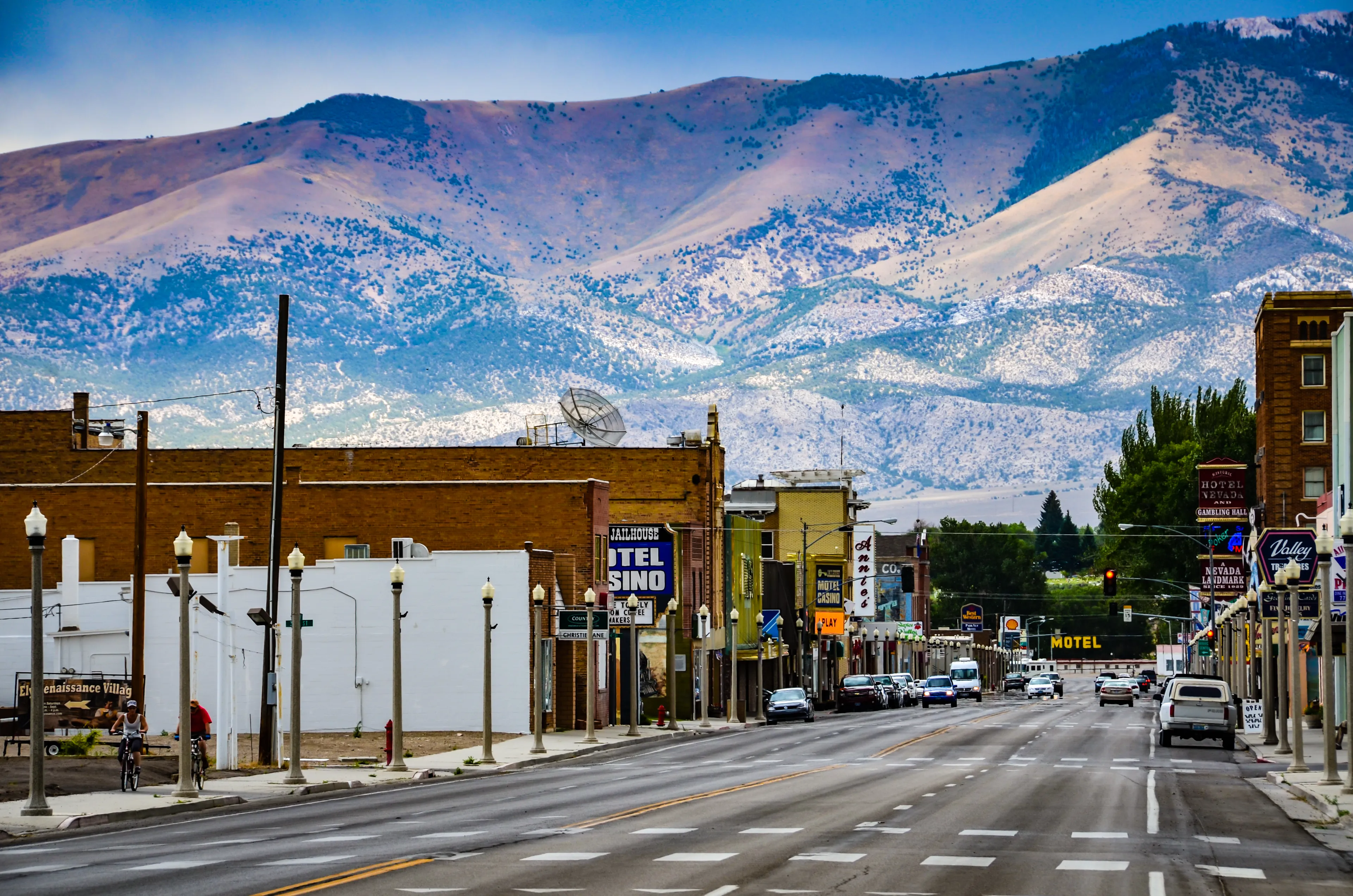 Ely, NV / USA - 08-17-2013: Route 50, the main street in western town of Ely, Nevada is seen against backdrop of mountain range. 