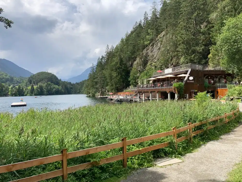 Piburger See, Oetz, Oetztal Valley, Tyrol, Austria - July 26, 2020: View over lake Piburger See and restaurant "Restaurant am See" Piburger See, Oetz, Oetztal Valley, Tyrol, Austria - July 26, 2020: View over lake Piburger See and restaurant "Restaurant am See"