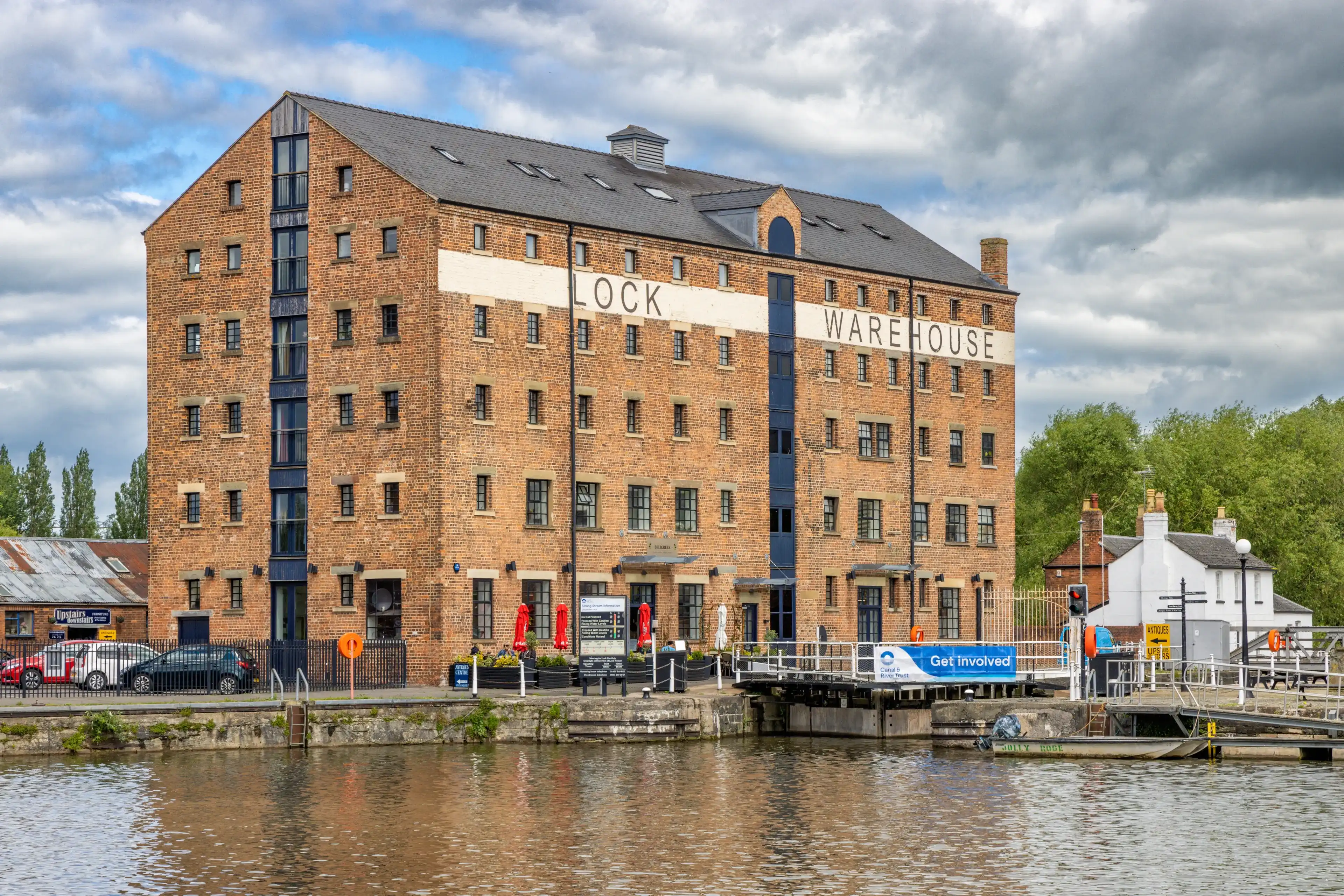 Gloucester, United Kingdom - May 29 2024: Lock Warehouse, a 19 Century Corn warehouse, on the North Quay of the Gloucester Docks, Gloucester, United Kingdom Gloucester, United Kingdom - May 29 2024: Lock Warehouse, a 19 Century Corn warehouse, on the North Quay of the Gloucester Docks, Gloucester, United Kingdom