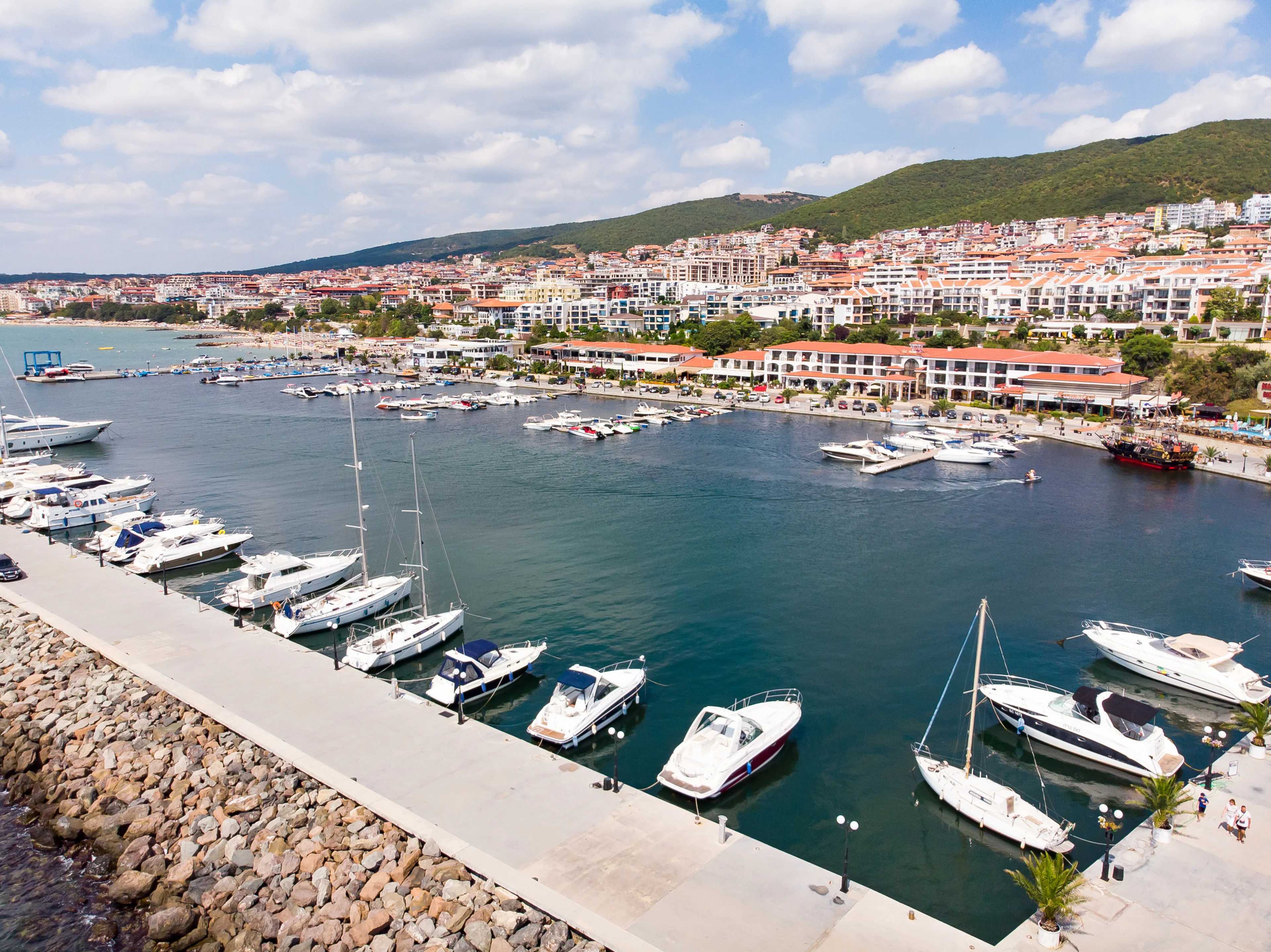 Summer holidays in Europe during quarantine. Panoramic aerial view of ships and yachts the sea port marina of Sveti Vlas in Bulgaria. Aerial photography, drone view.