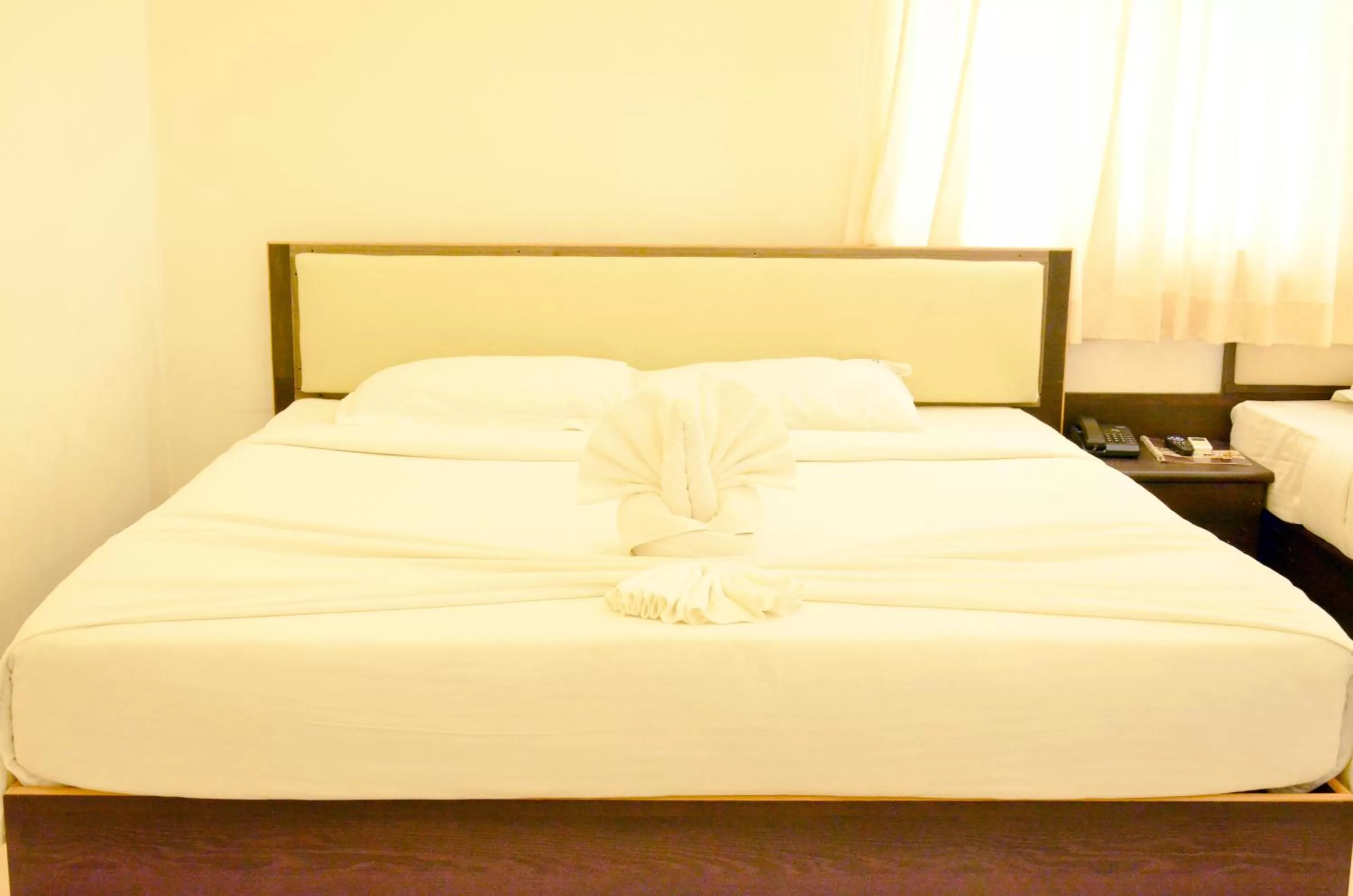 Bed in Hotel Ambai Grand