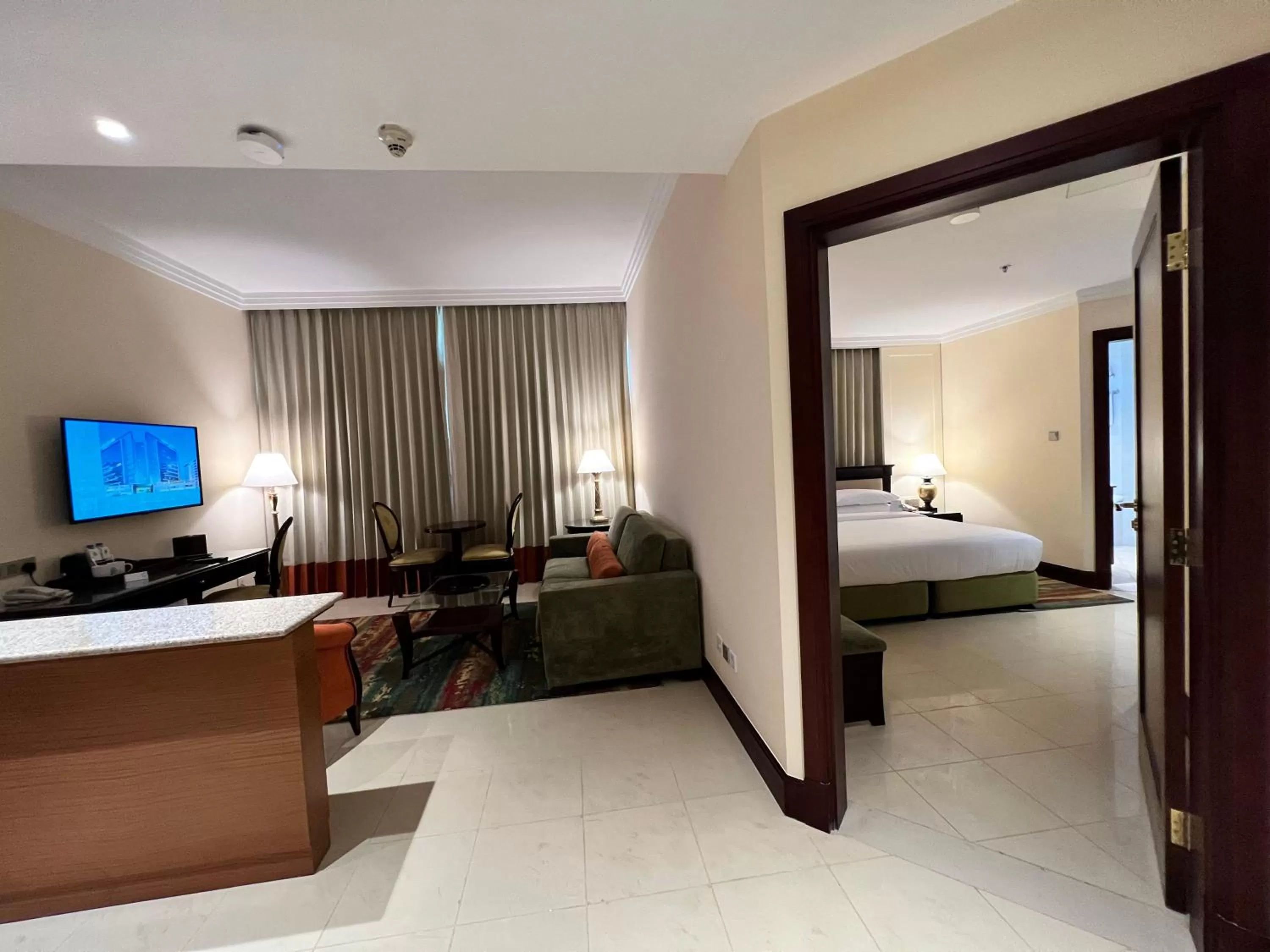 Living room, Bed in City Seasons Suites