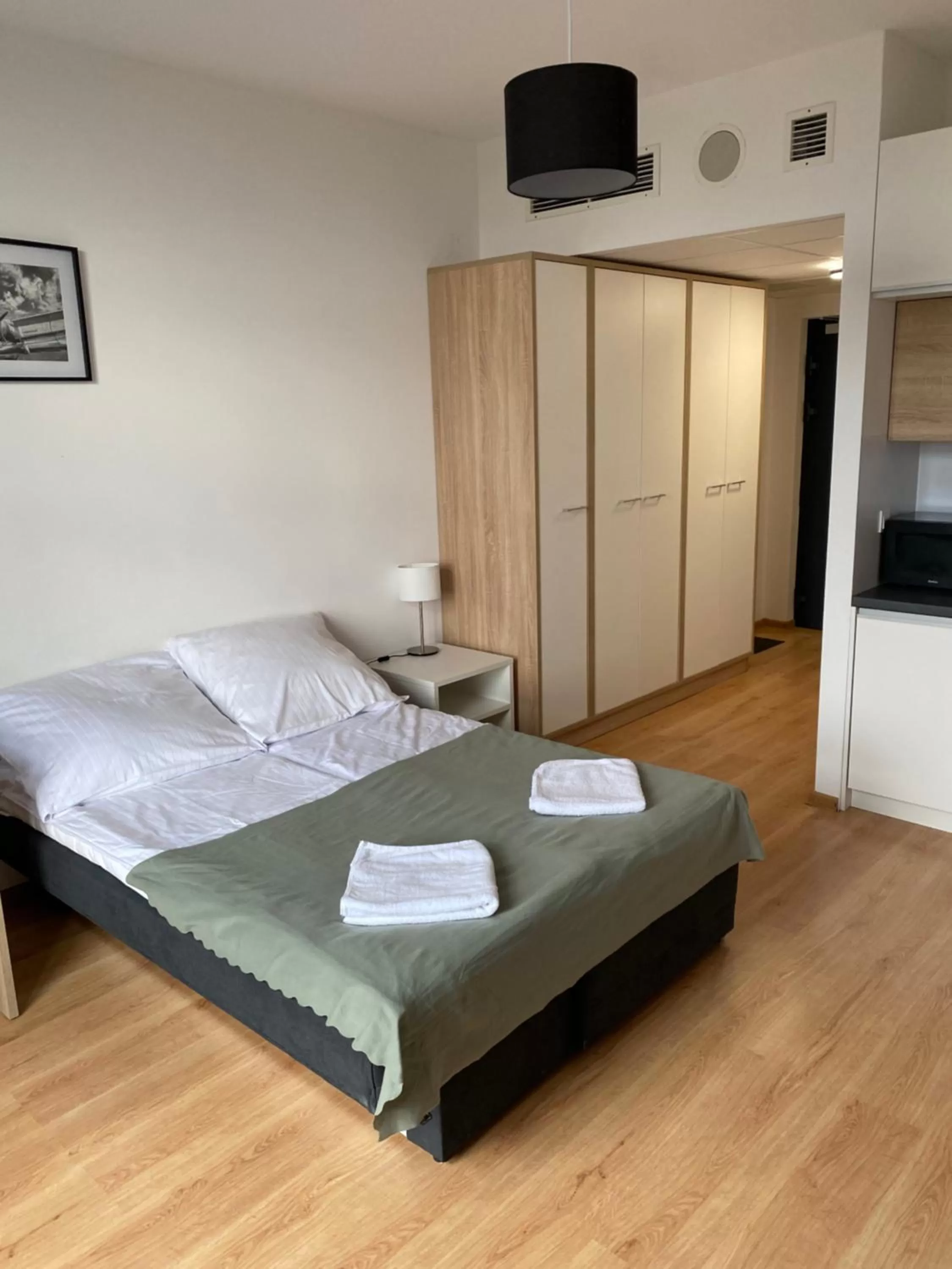 Bed in SleepWell Apartments