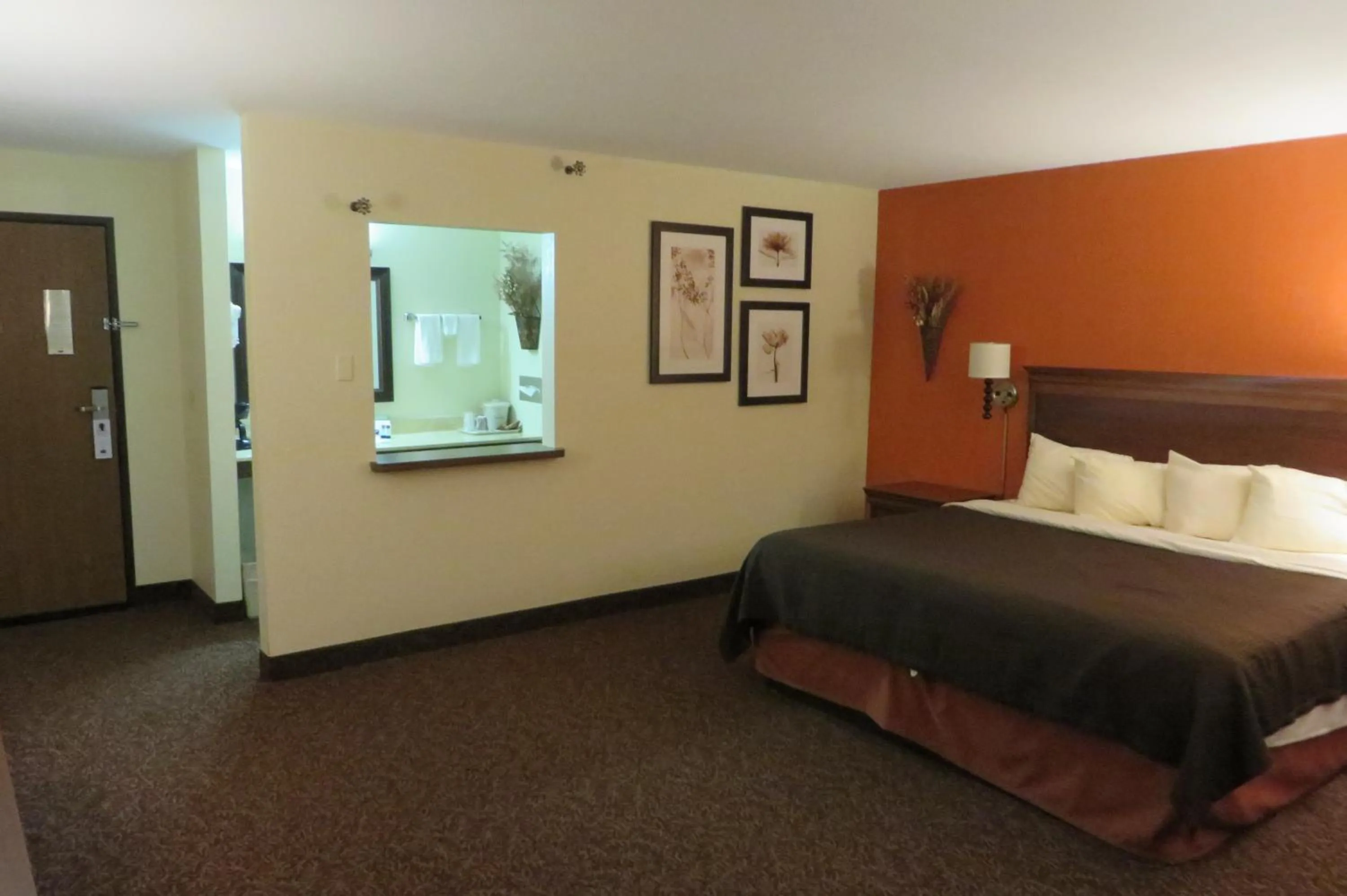 Bed in AmericInn by Wyndham Forest Lake