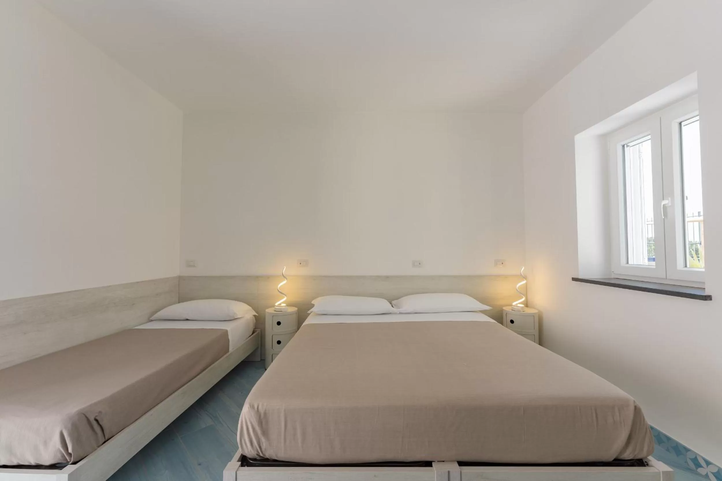 Bed in Poseidonia Rooms