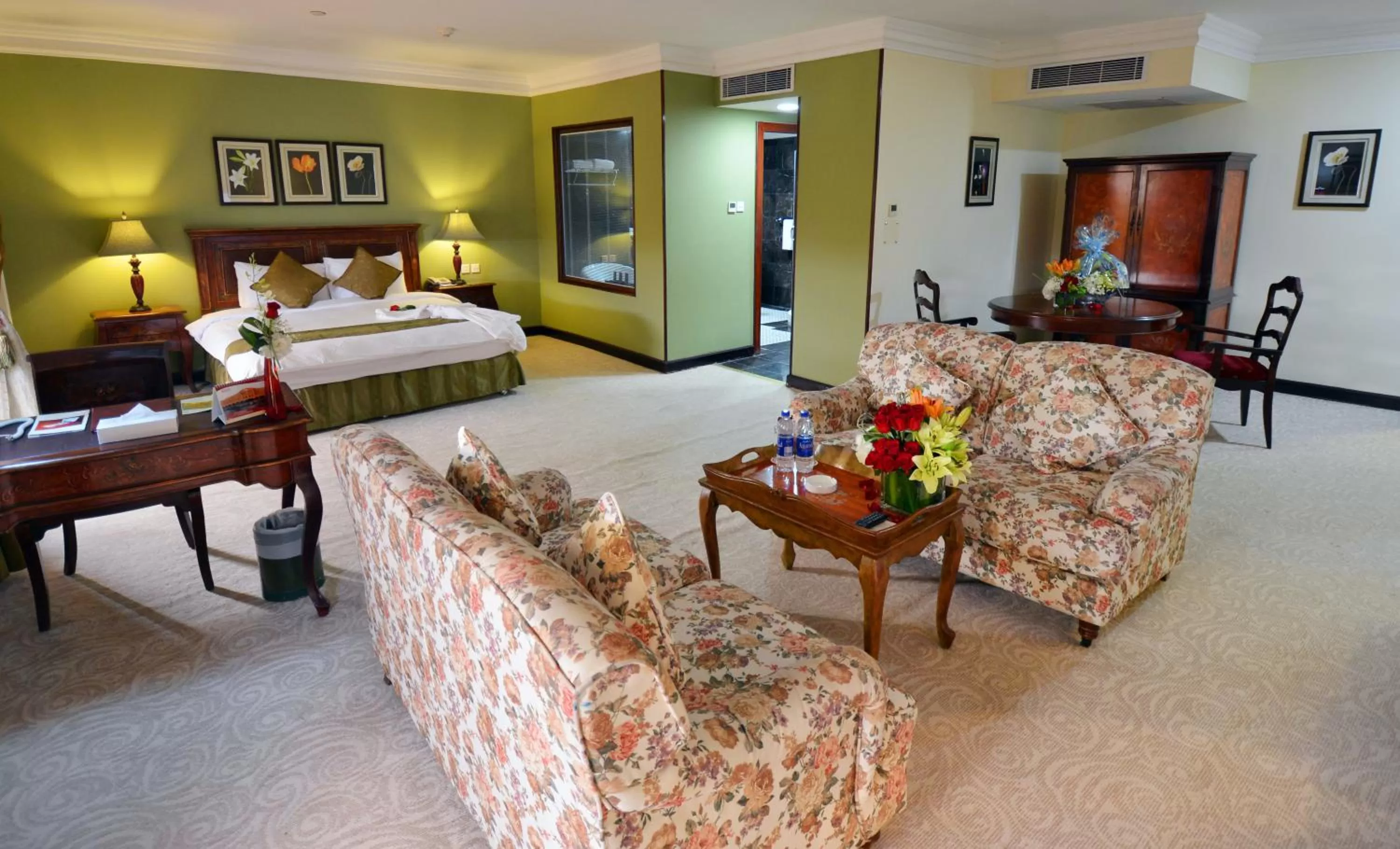 Living room, Bed in The Convention Center & Royal Suites Hotel