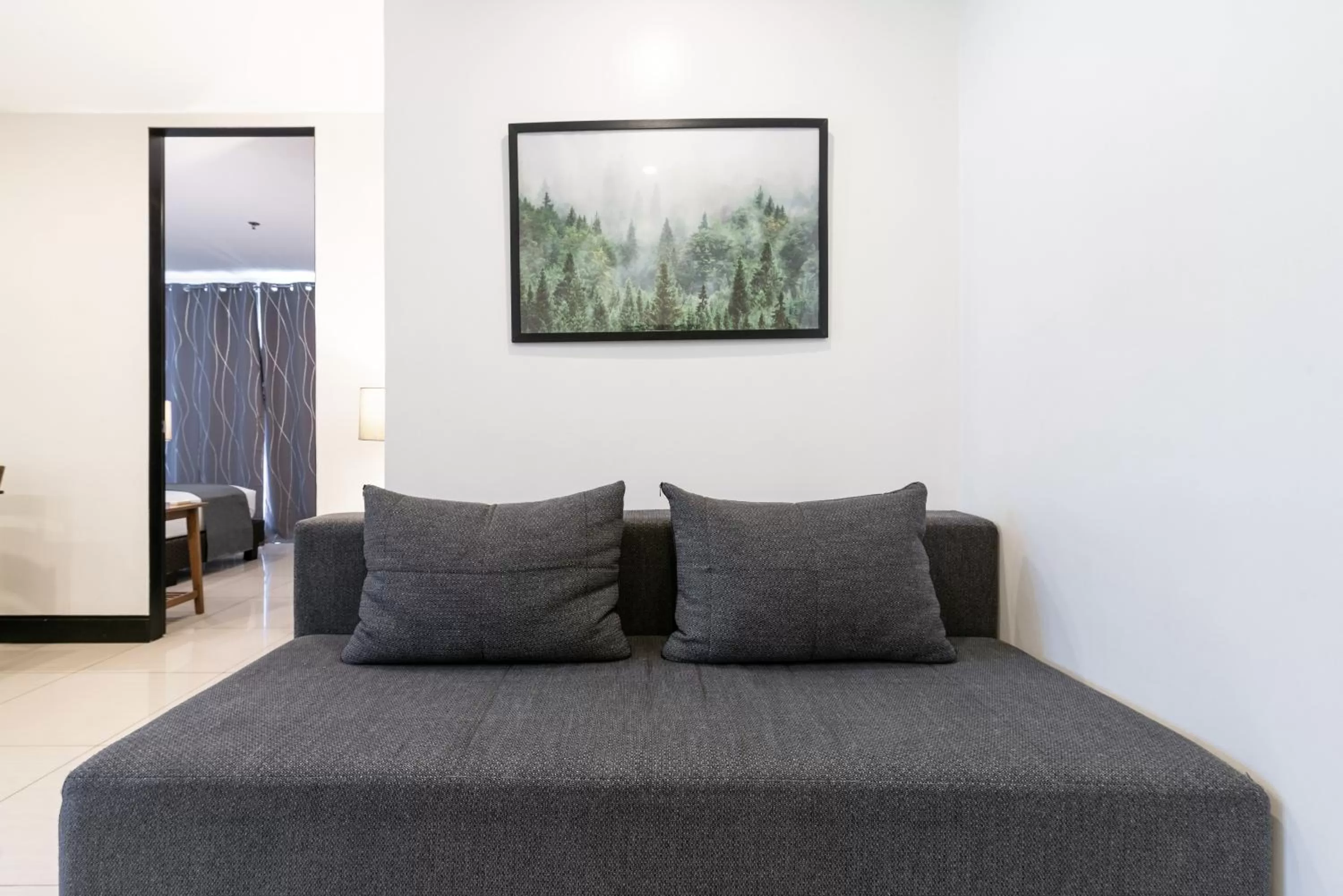 Living room, Bed in Artemis Place Makati Hotel