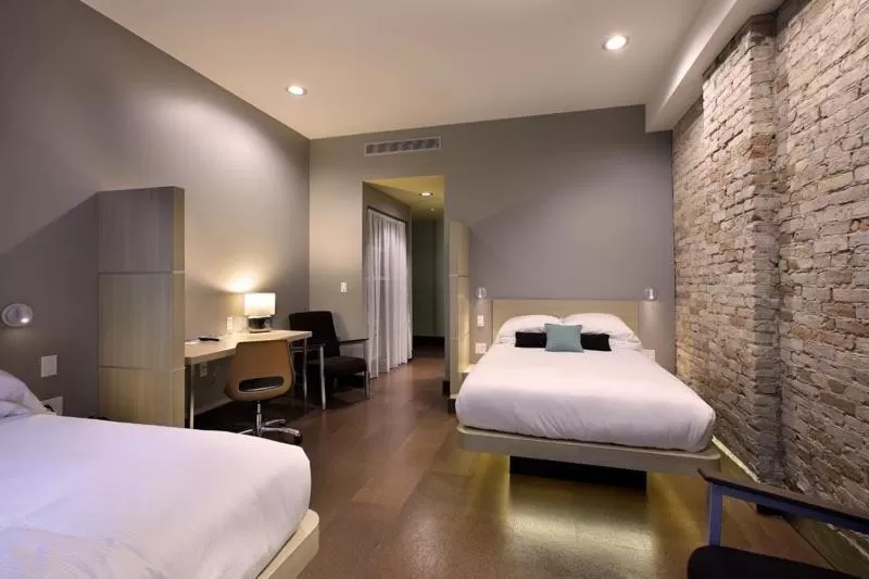 Bed in CityFlatsHotel - Grand Rapids, an Ascend Collection Hotel