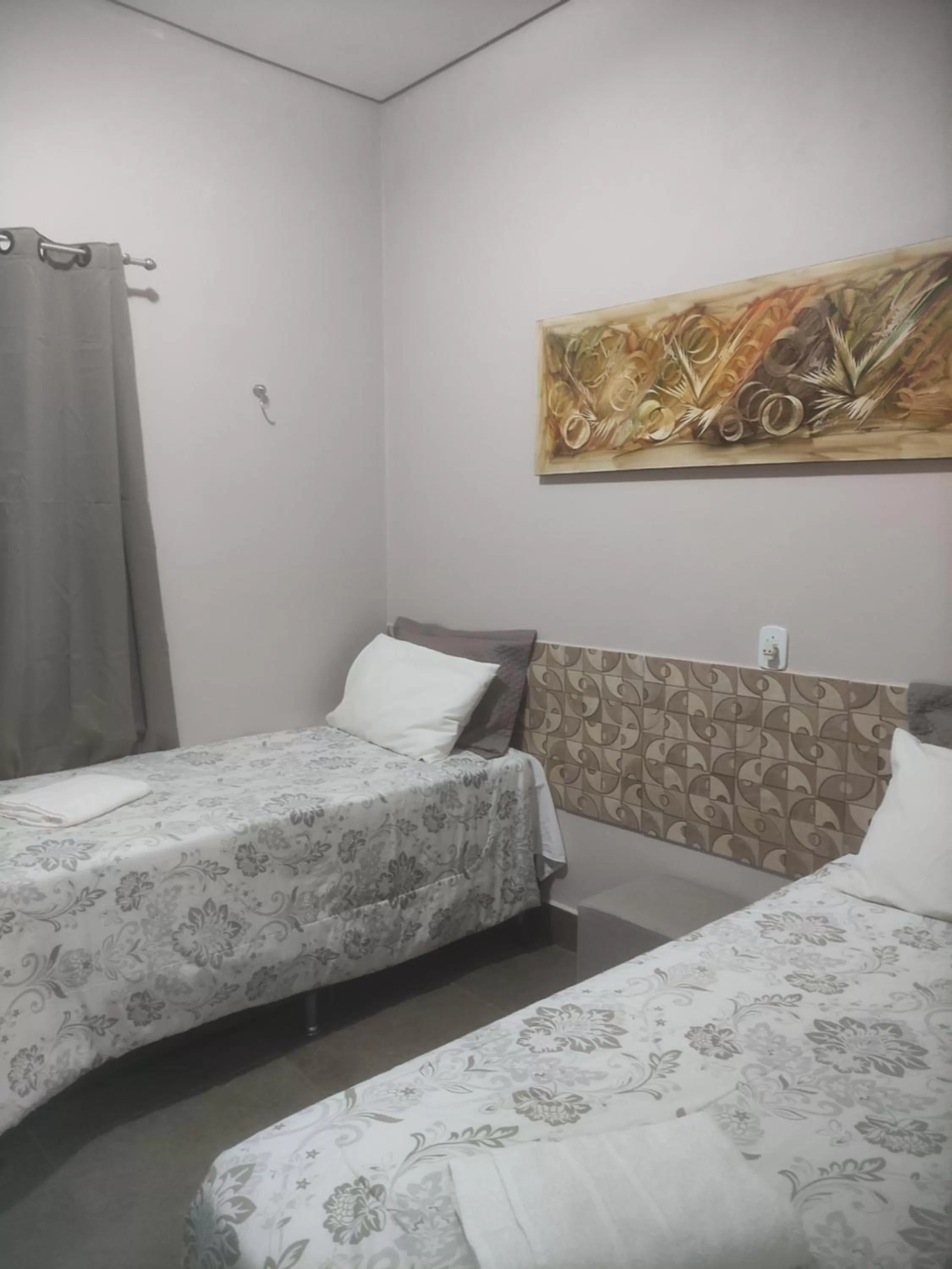 Bed in Pousada da Gi Suítes e Turismo