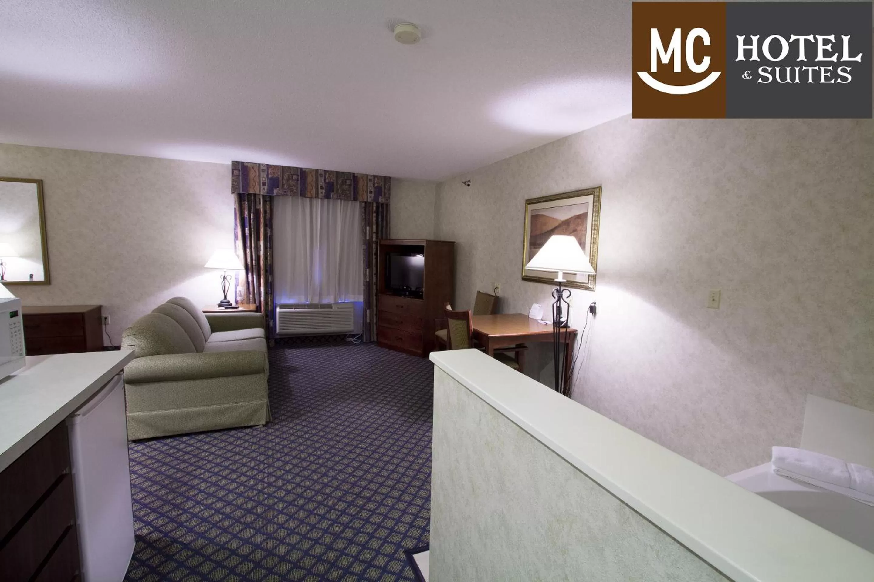 Seating area, Bed in Miles City Hotel & Suites