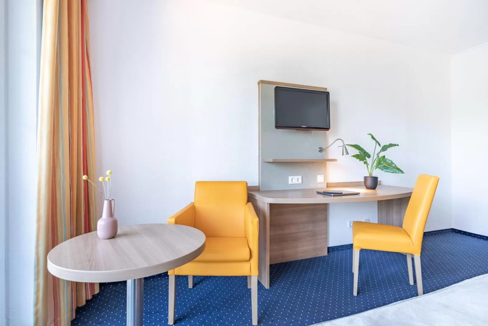 Living room in acora Düsseldorf Living the City - Apartments