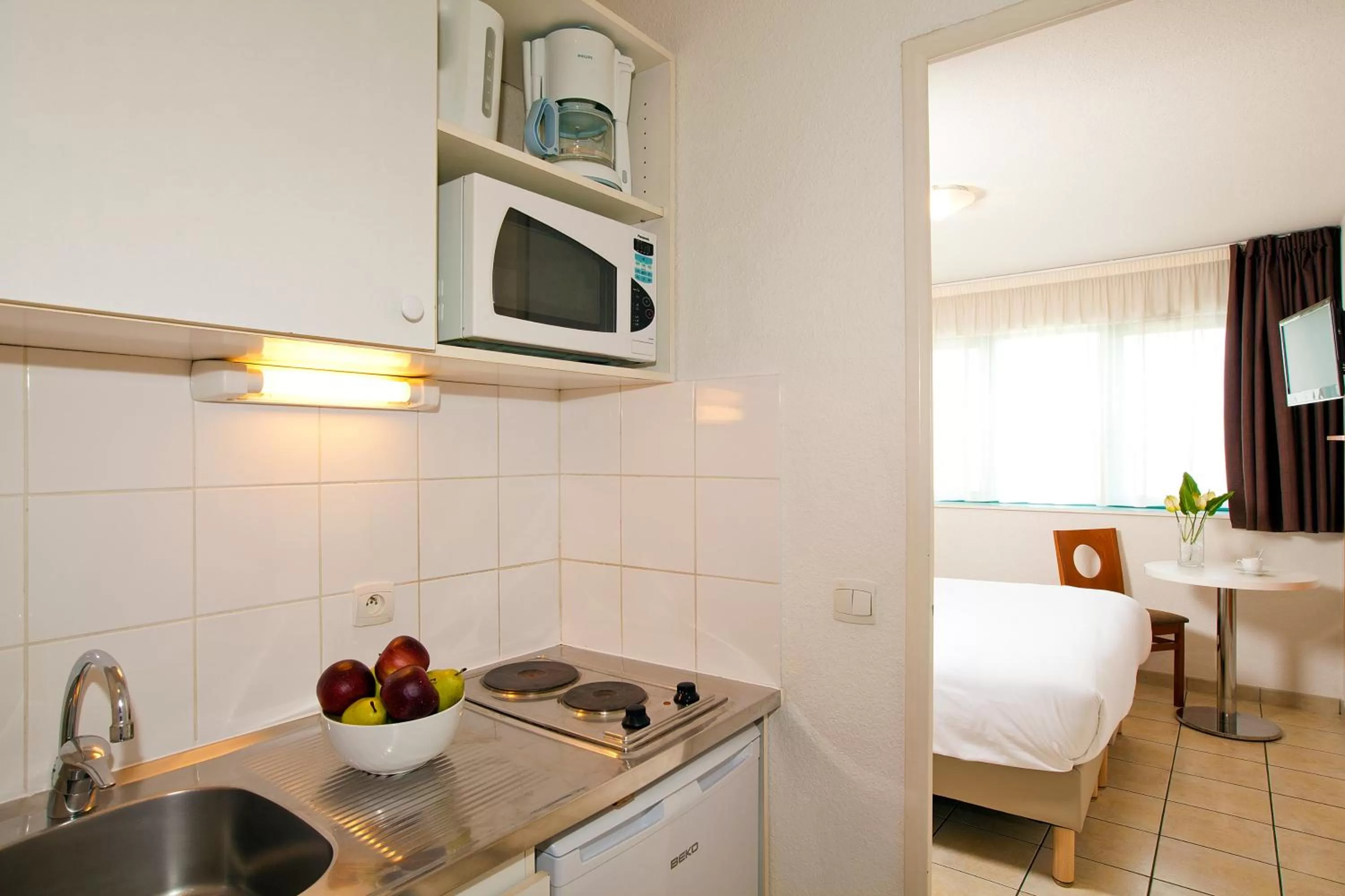 Kitchen or kitchenette in Séjours & Affaires Serris Rive Gauche