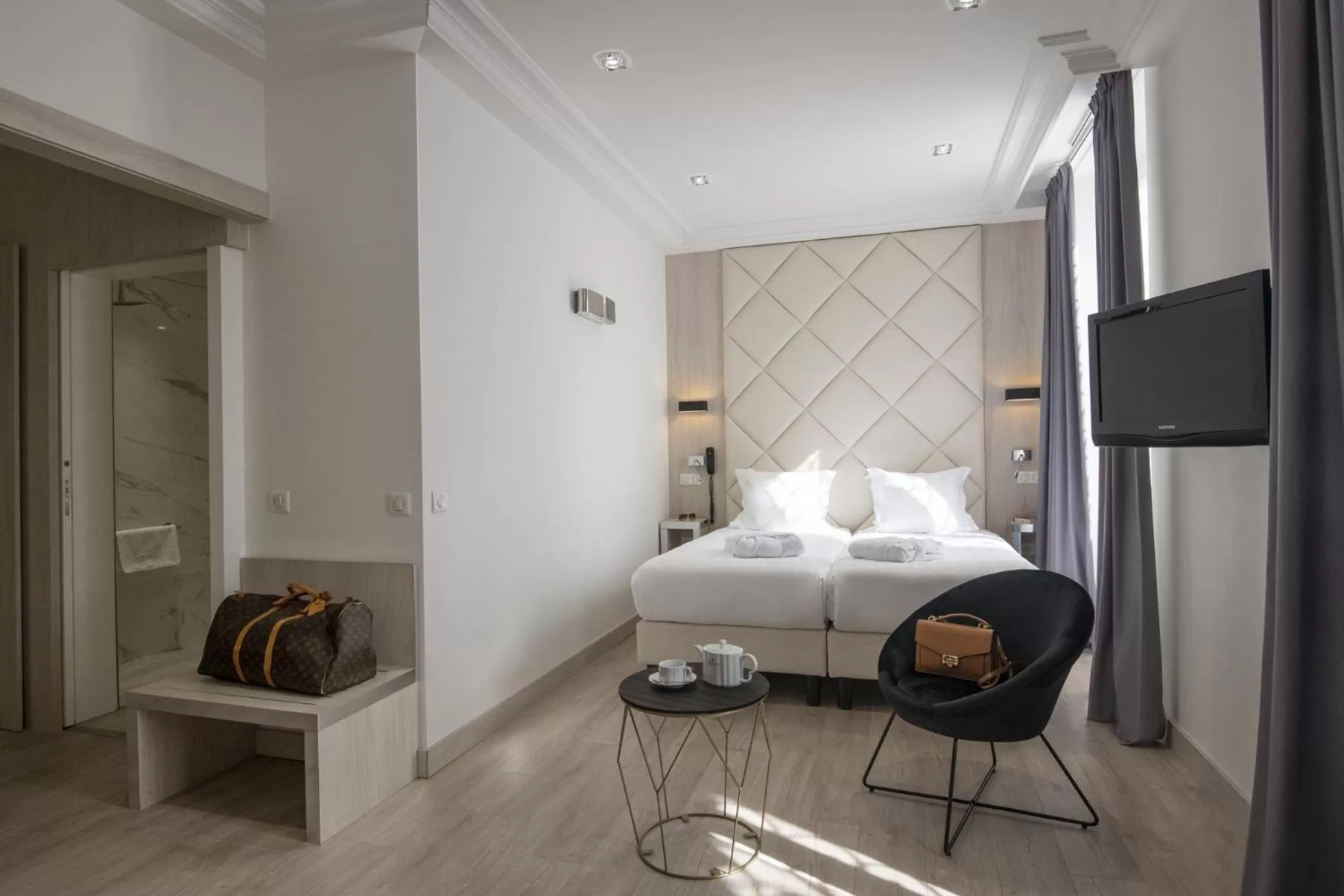 Photo of the whole room, Bed in GOLDEN TULIP CANNES HOTEL de PARIS