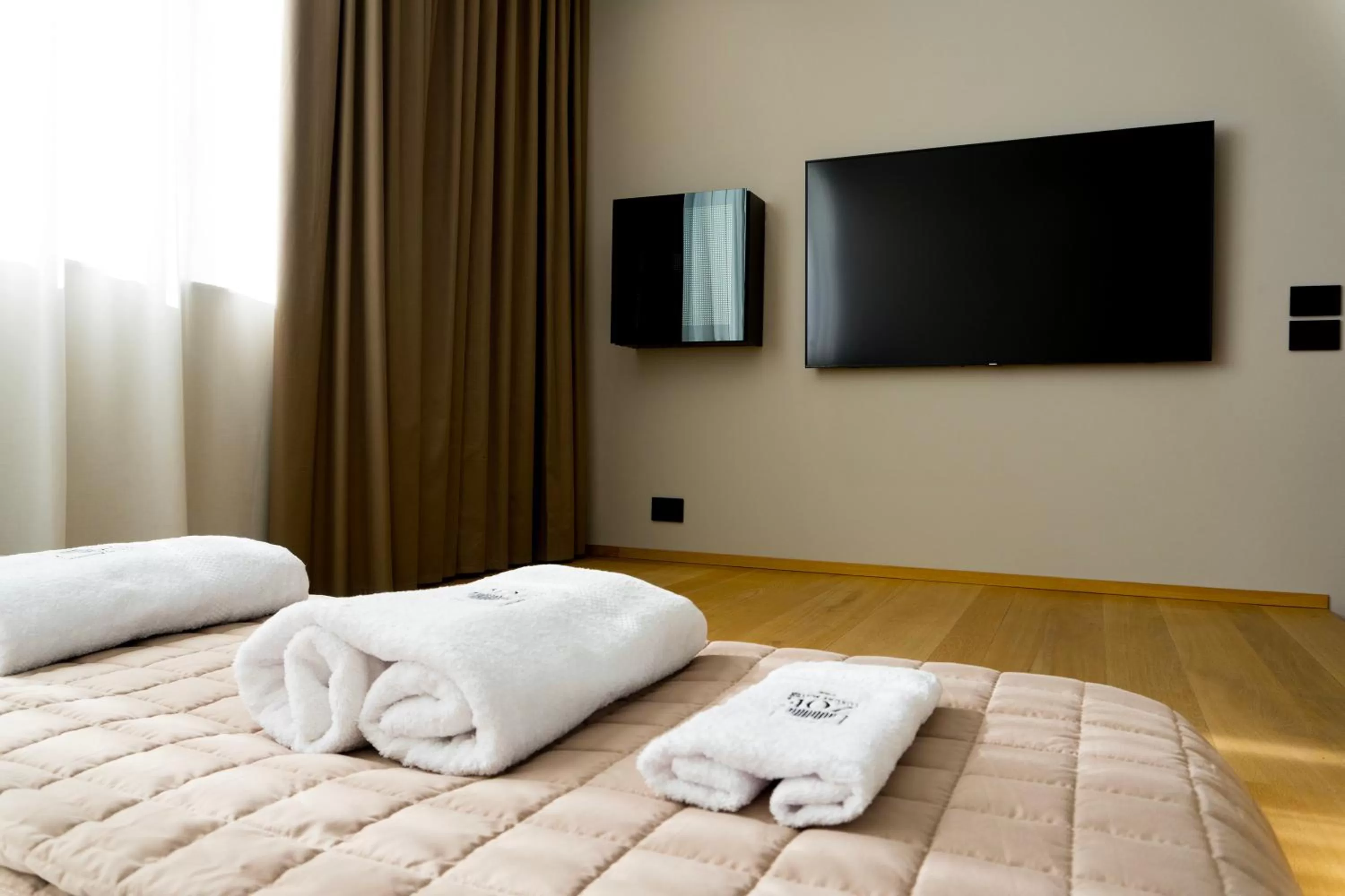 Bed, TV/Entertainment Center in ZOE LUXURY SUITES