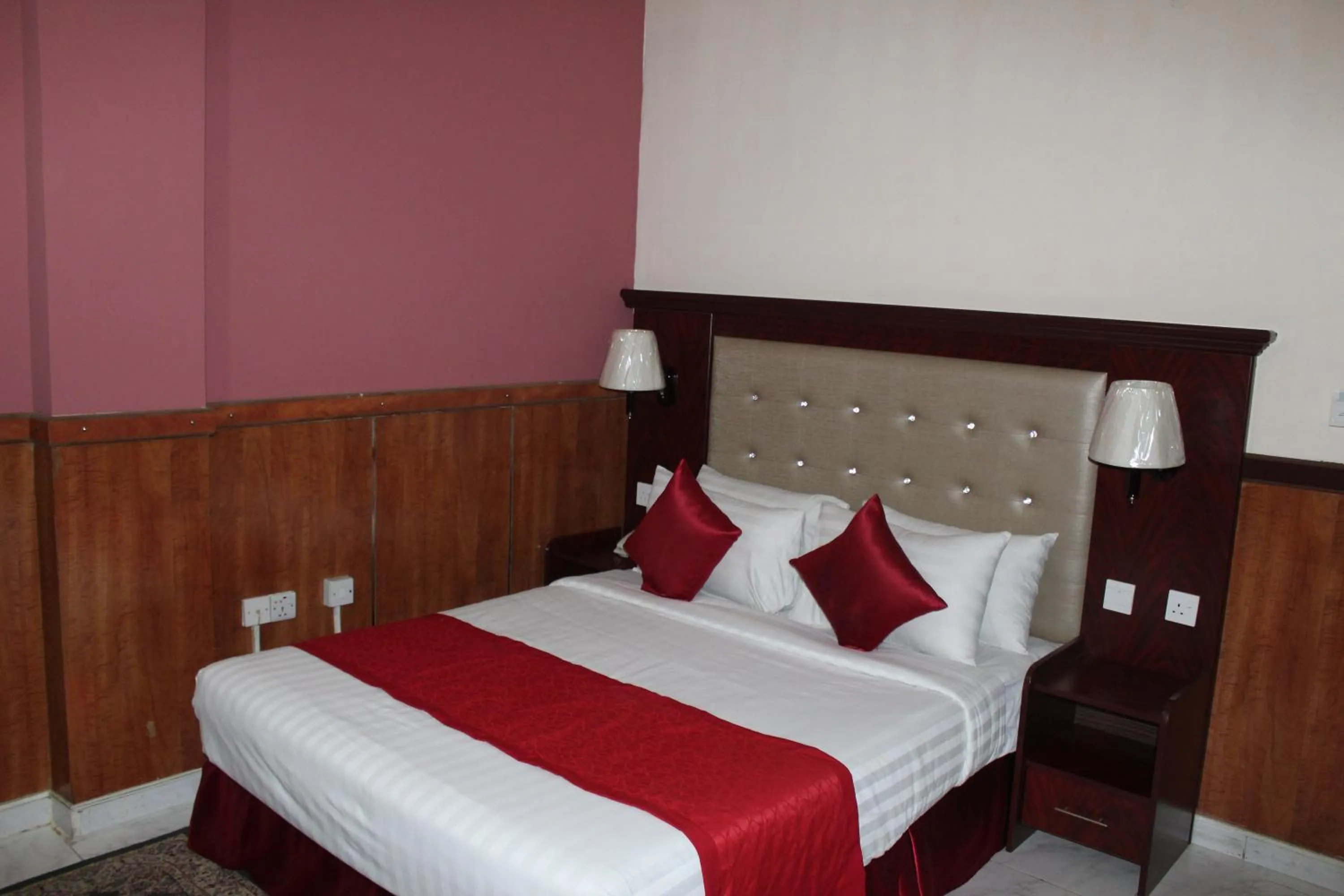 Bed in Grand Nova Hotel