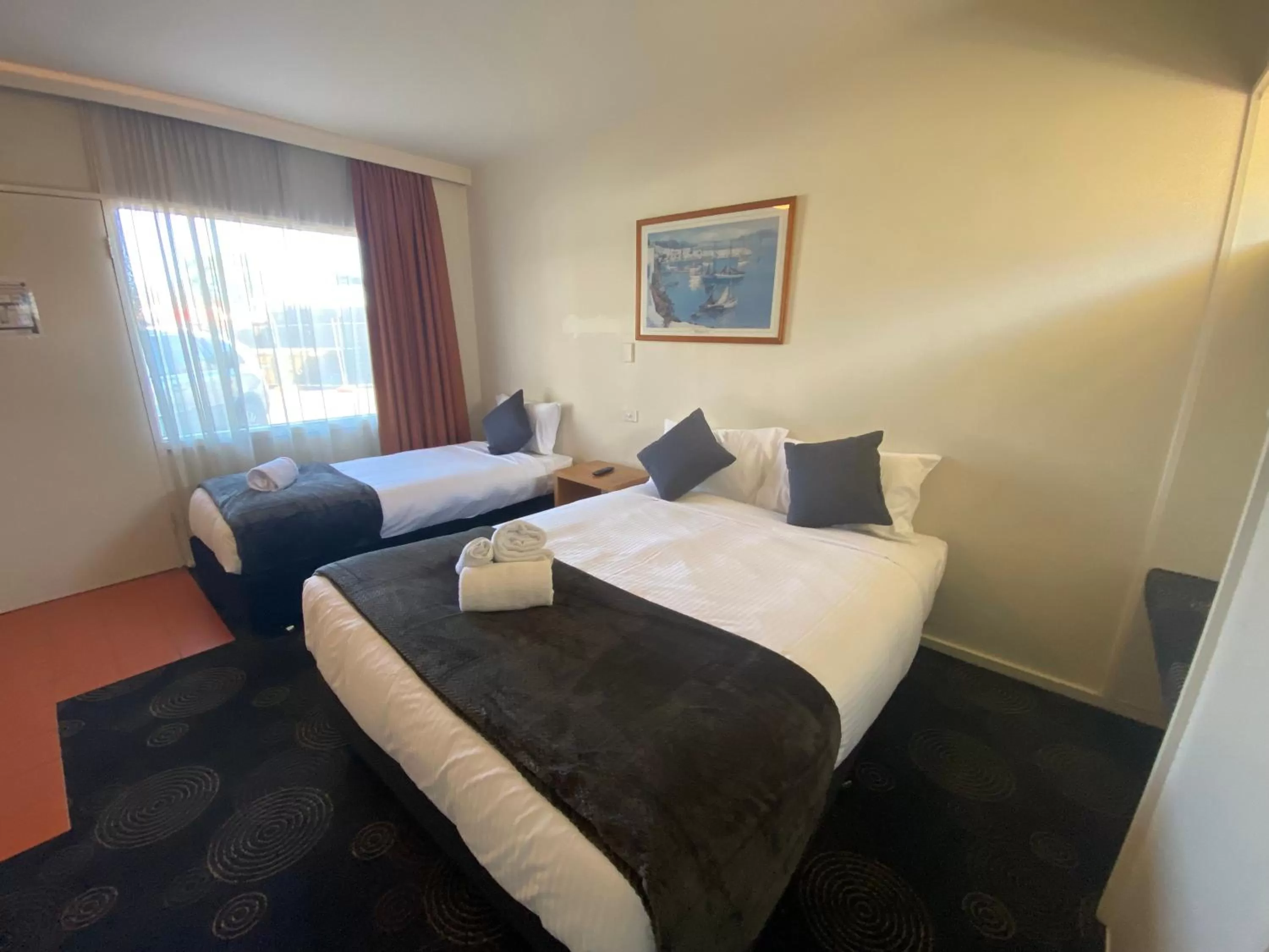 Bed in The Astor Hotel Motel