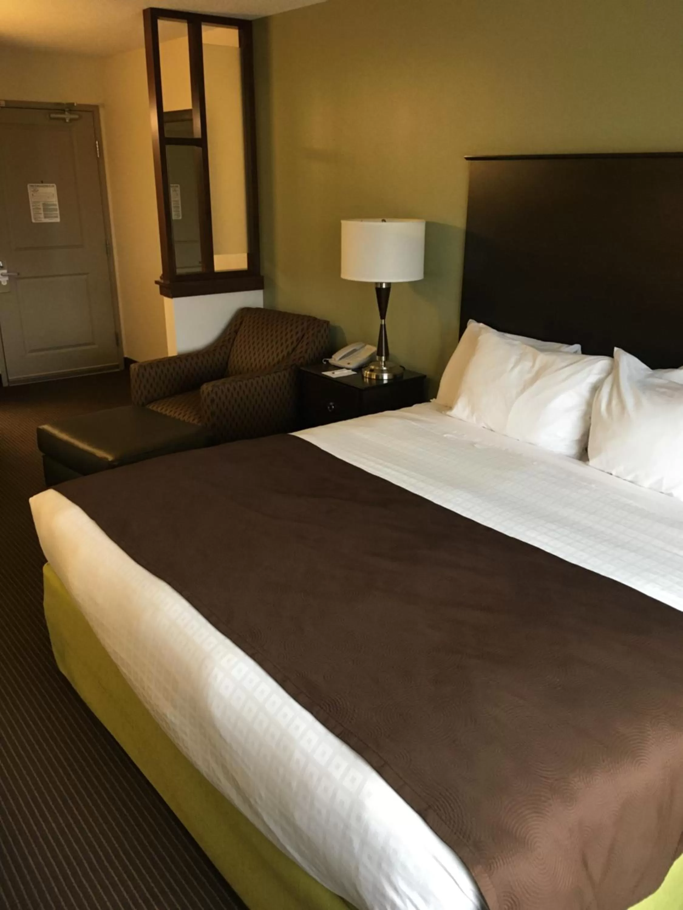 Bed in AmericInn by Wyndham Fairfield