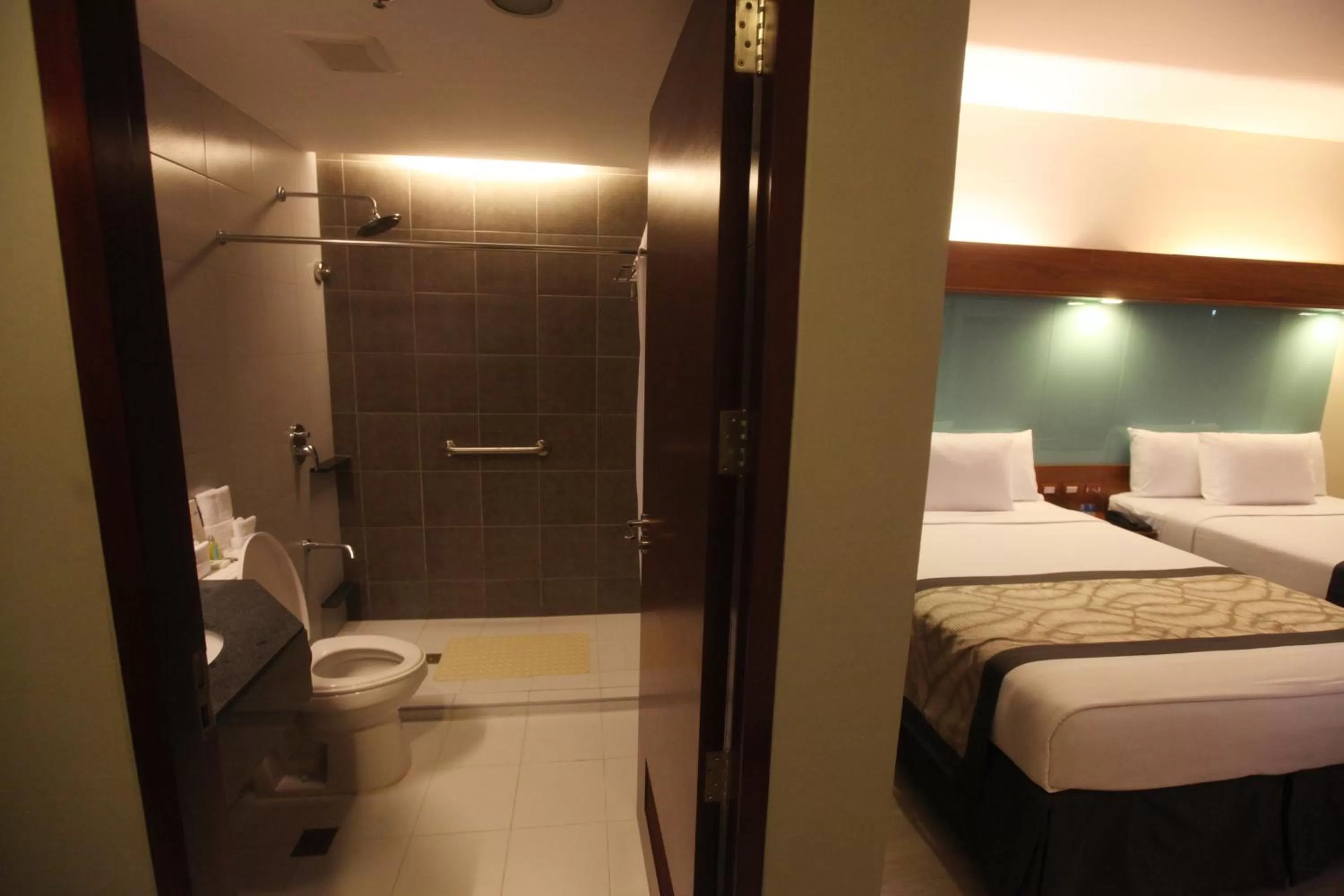 Toilet, Bed in Microtel by Wyndham UP Technohub