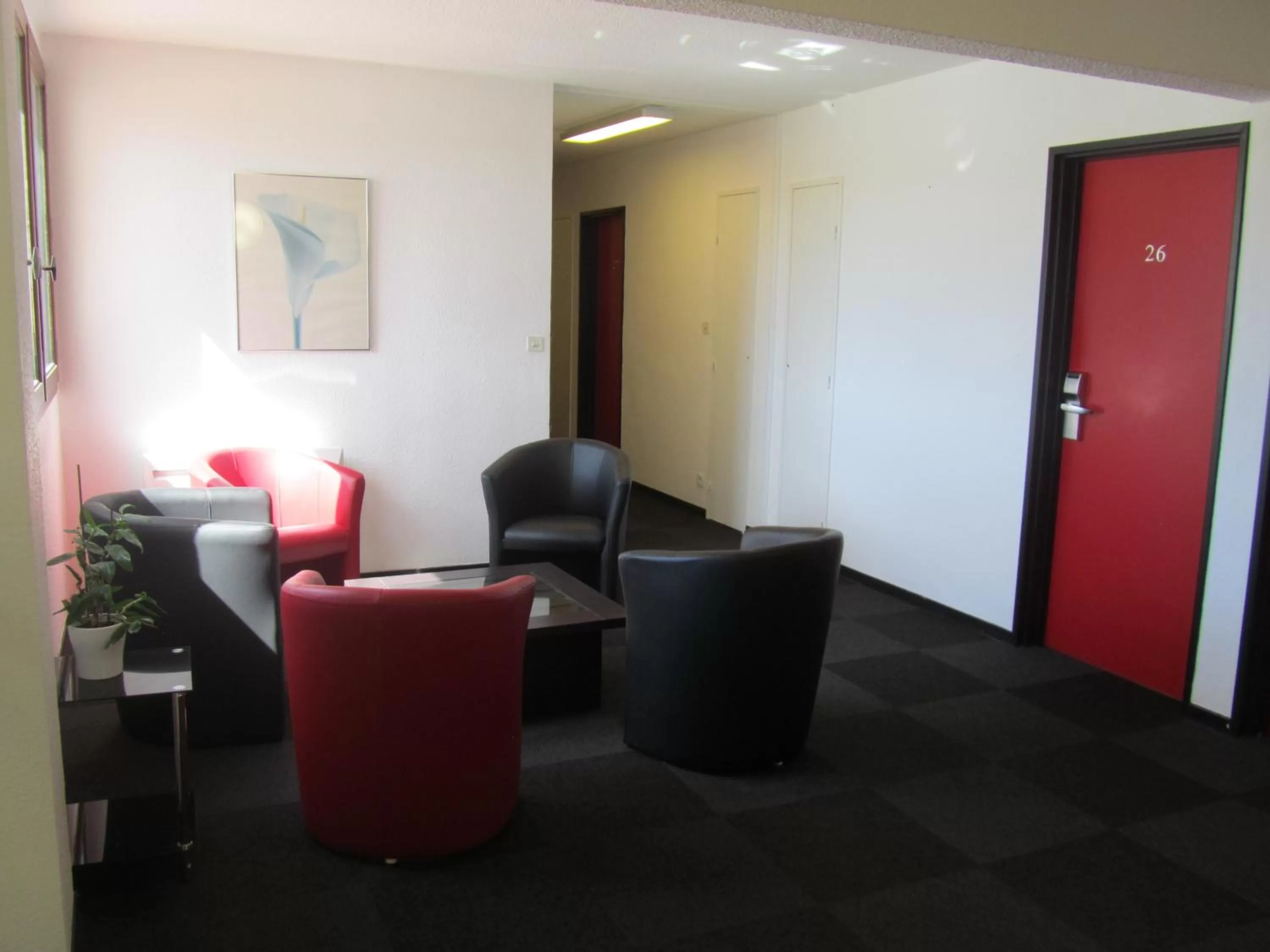 Communal lounge/ TV room in Hôtel Le Saint Joseph