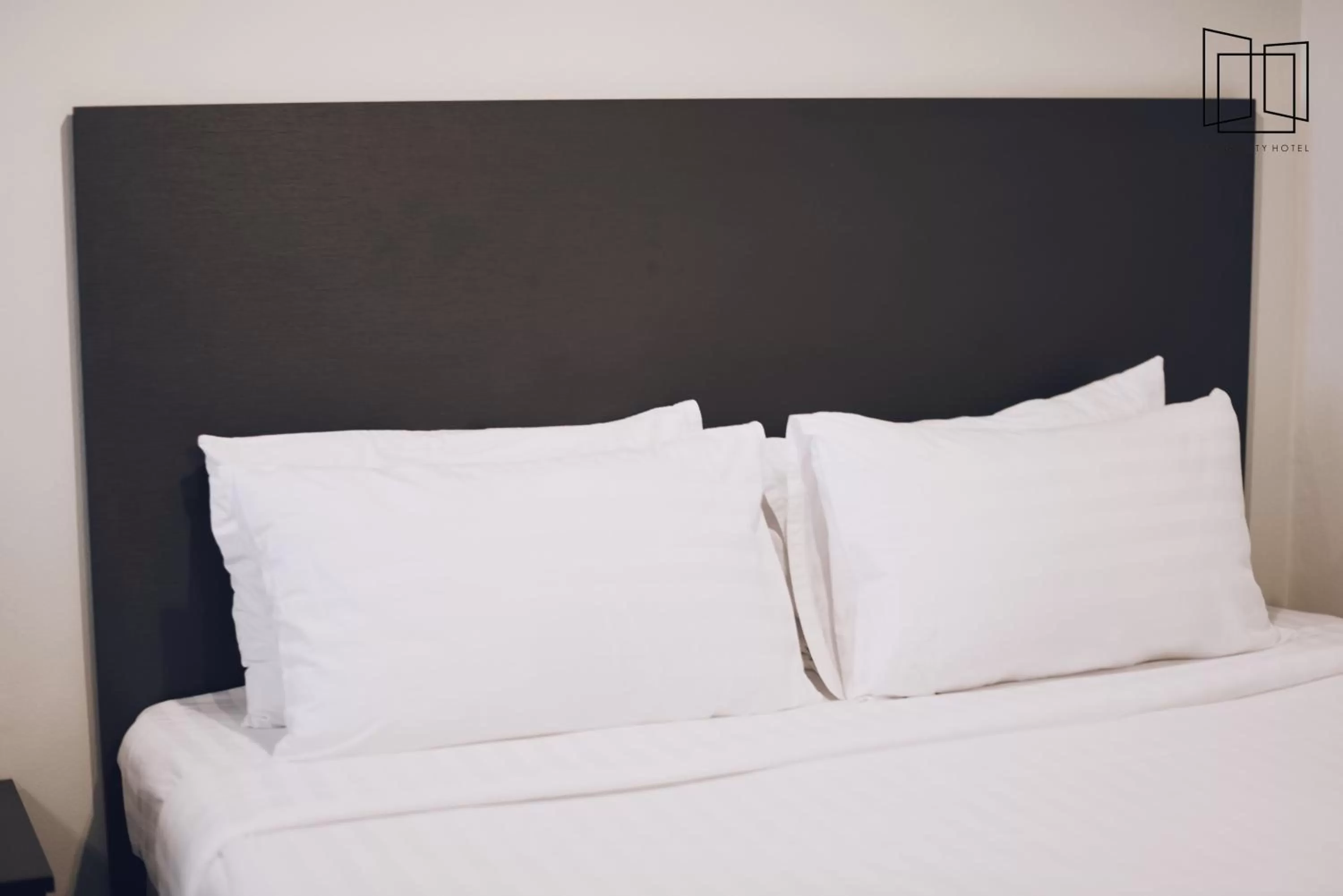 Bed in Nana City Hotel