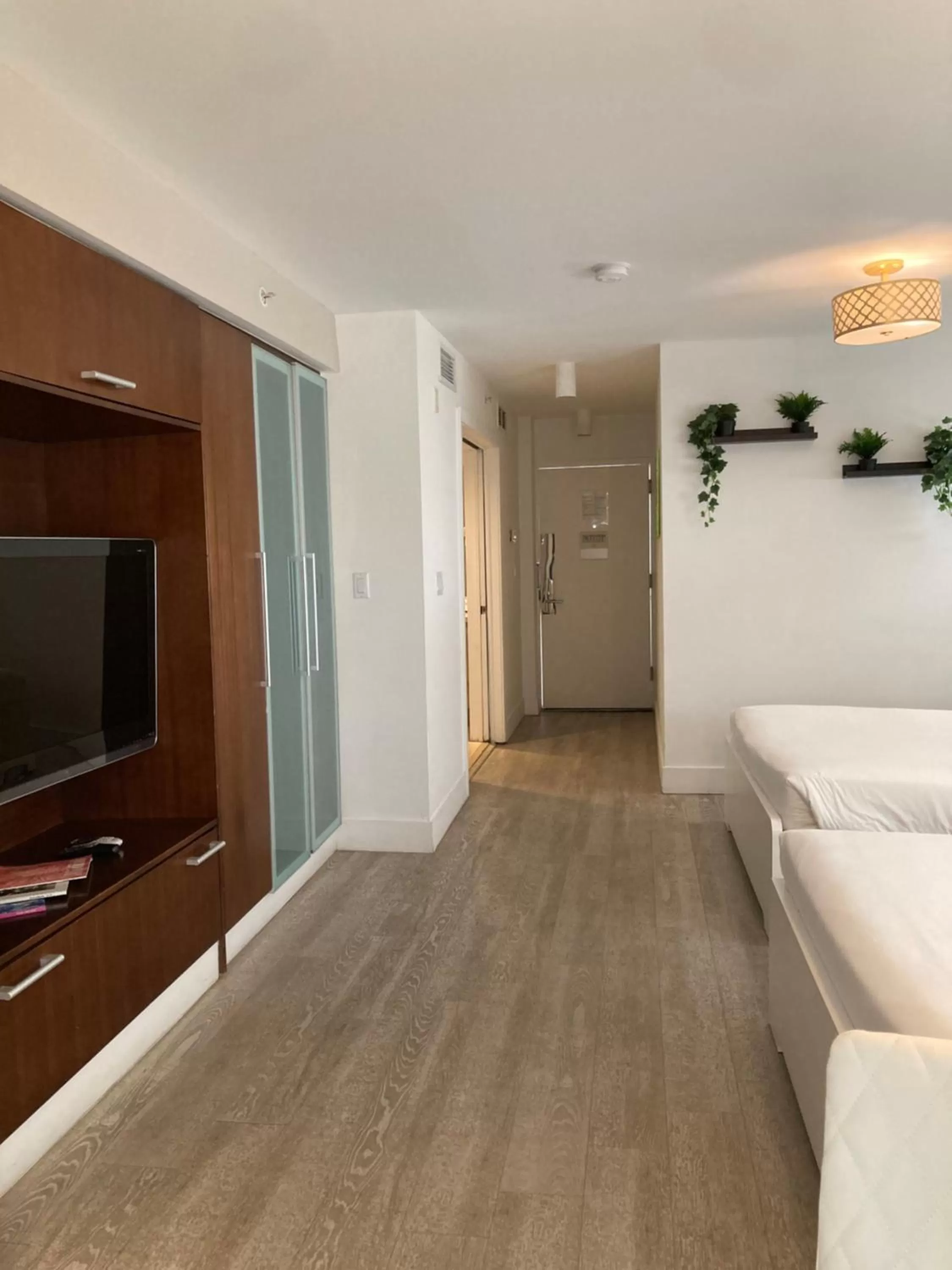 Bedroom, TV/Entertainment Center in Suites at The Strand on Ocean Drive