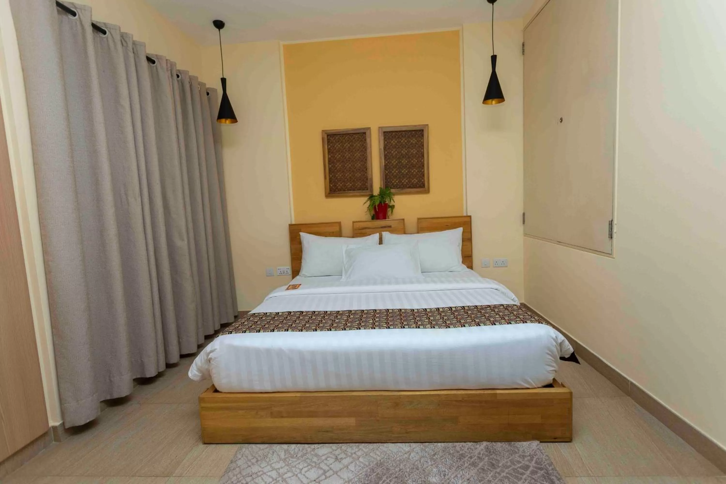 Bed in Roots Hotel Apartment