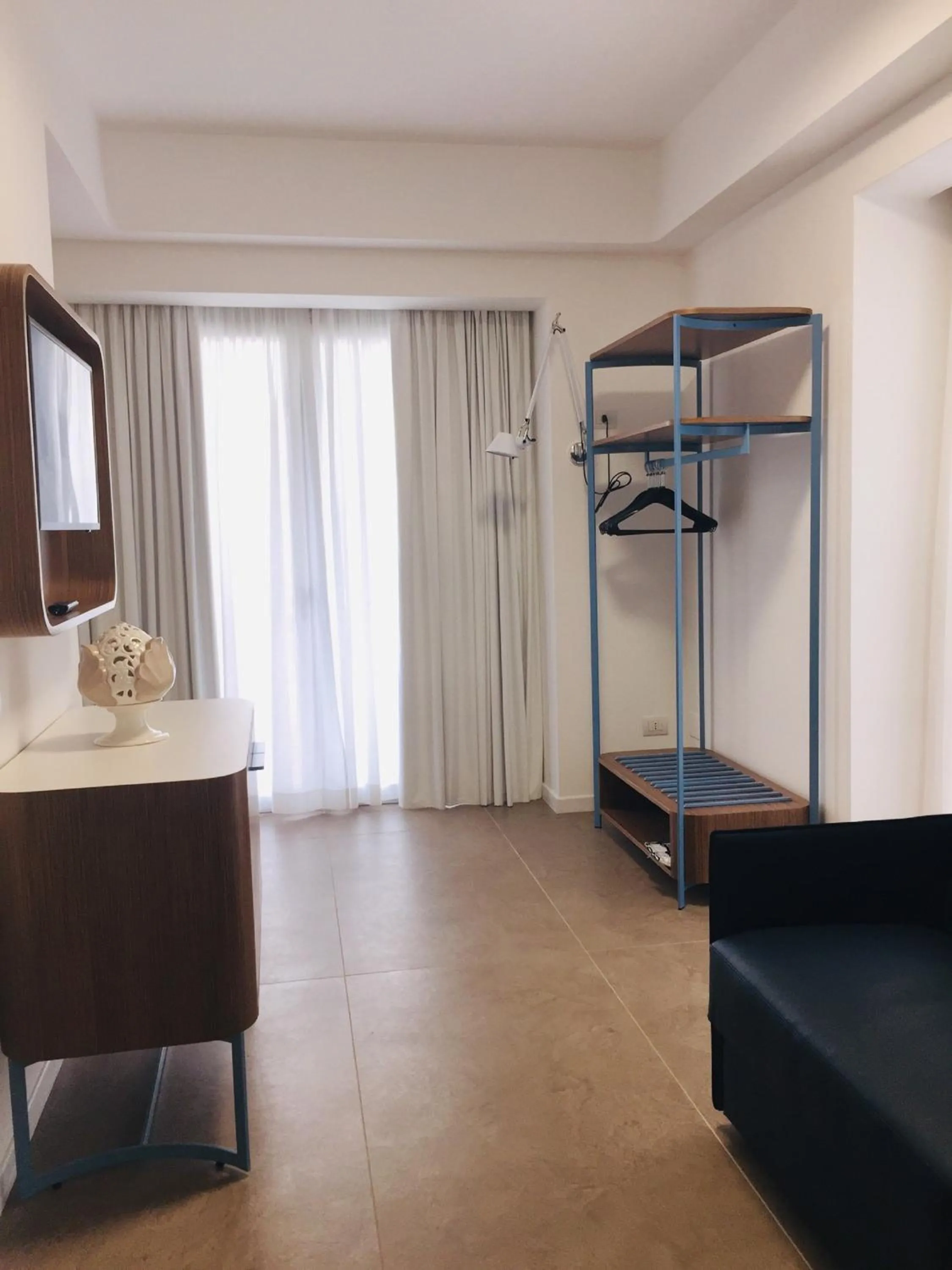 Seating area, Bed in M&F Hotel