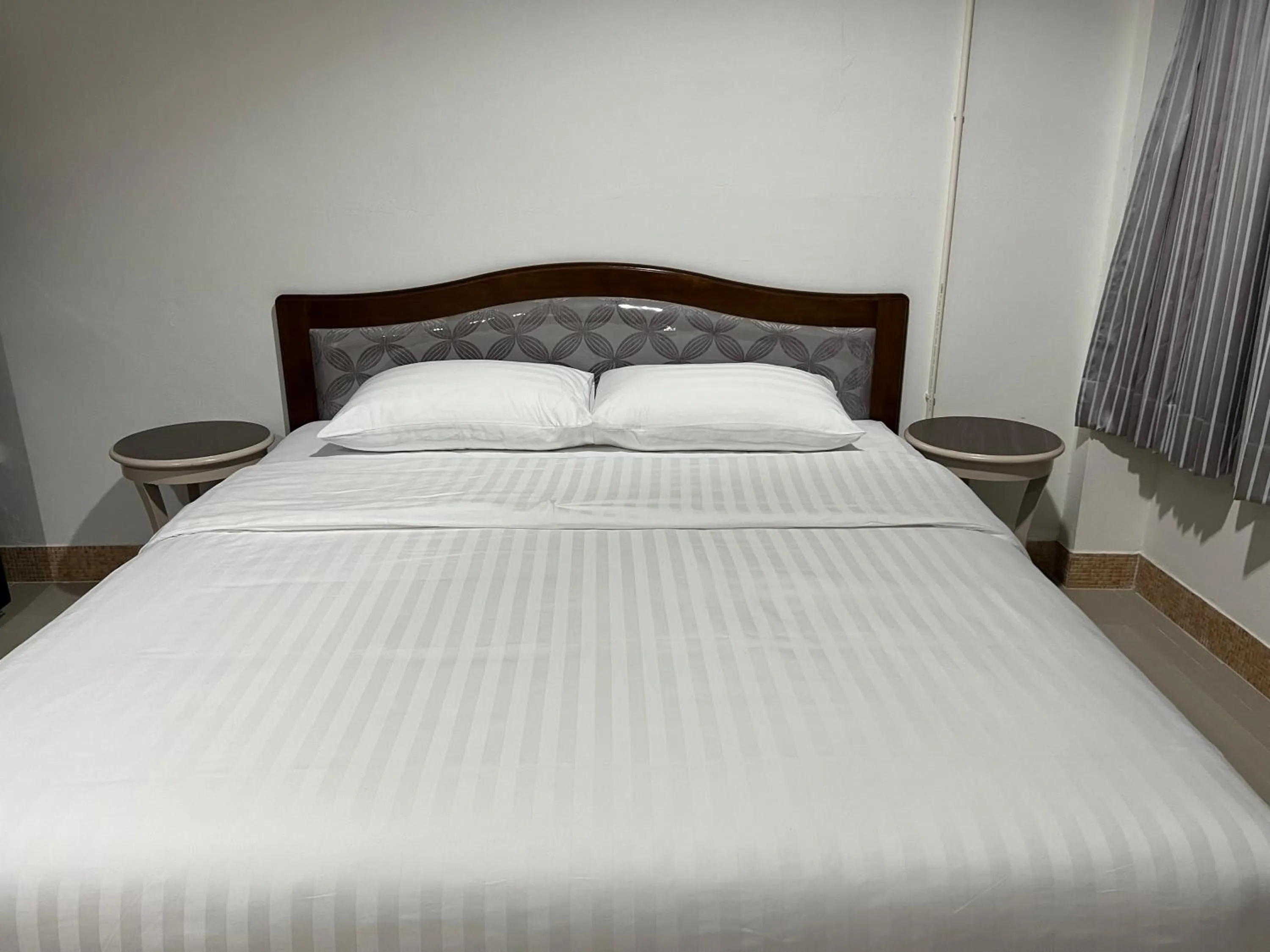 Bed in Mall Suites Hotel