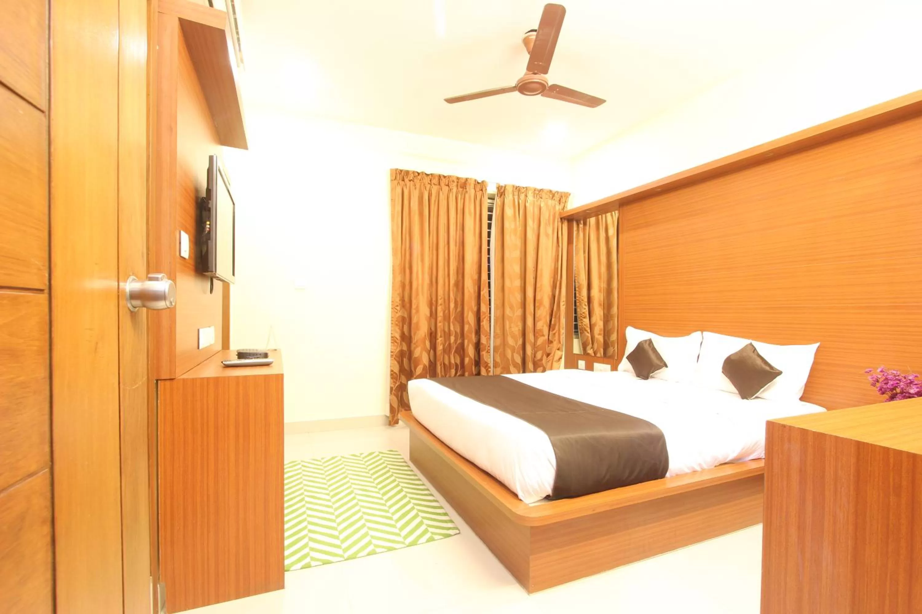 Bed in The Grand Inn Mysore