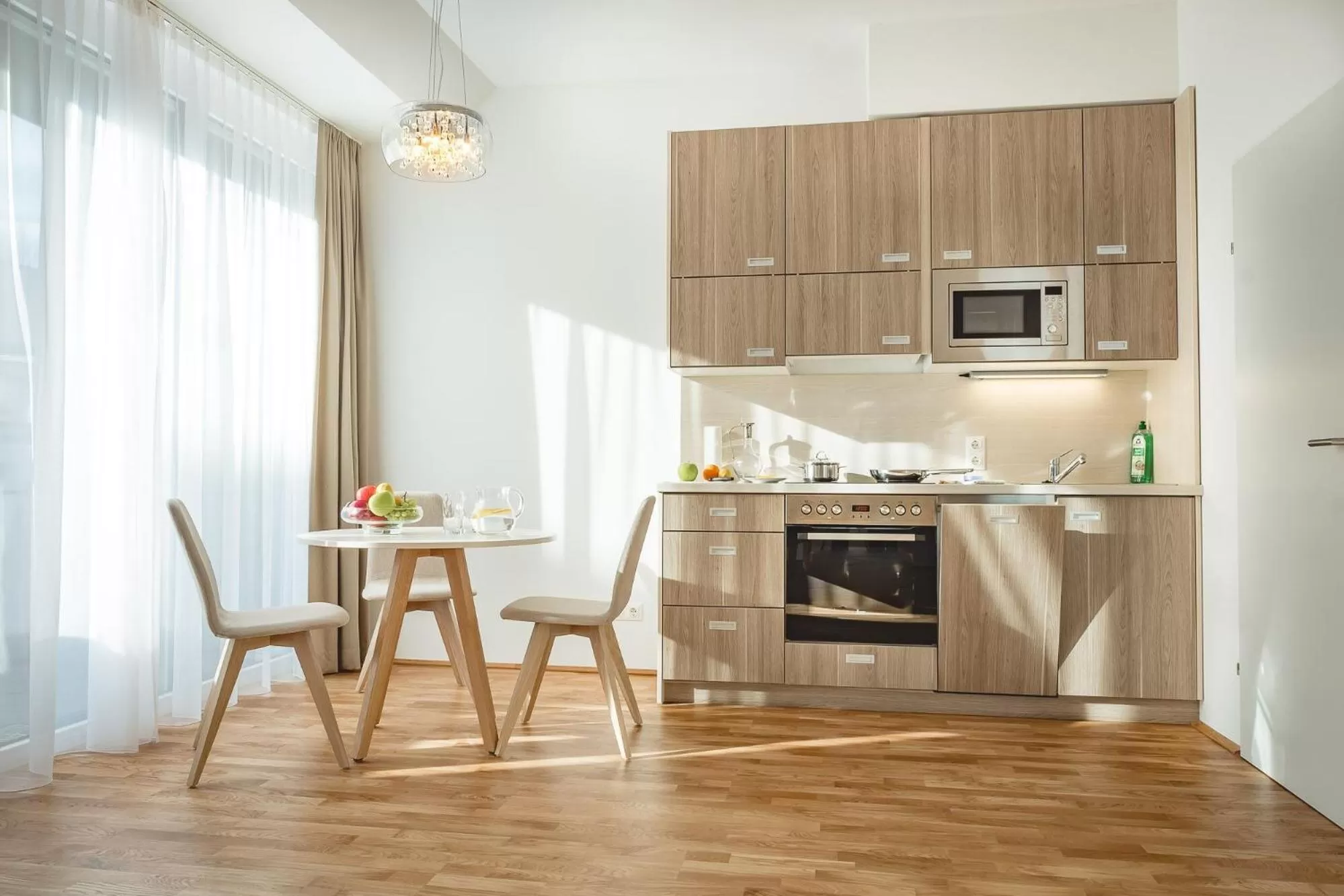 Kitchen or kitchenette in Oliver Apartments | contactless check-in