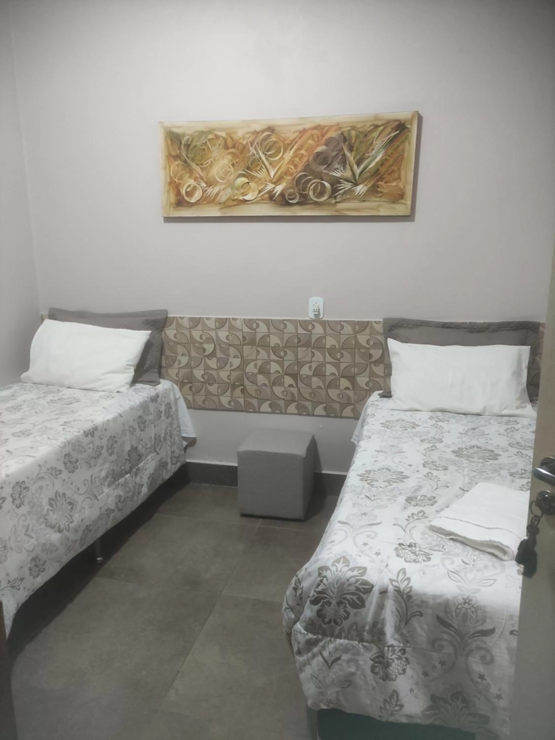 Bed in Pousada da Gi Suítes e Turismo